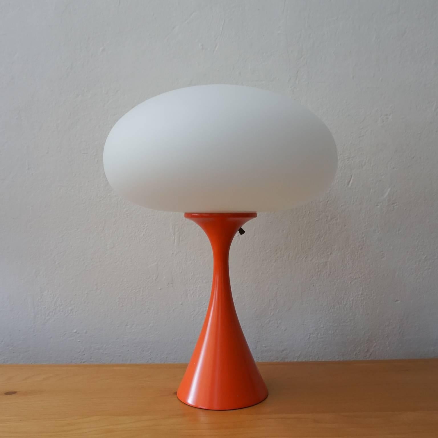 1960s table lamp by Laurel. Original orange enamel metal base with a glass shade.