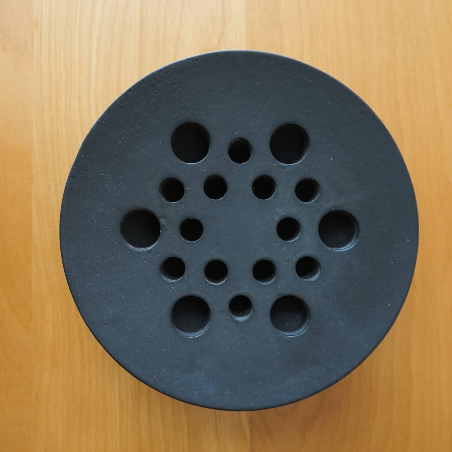 A 1960s cast iron tripod candle holder, designed by Jens Quistgaard for Dansk. Signed in the metal.