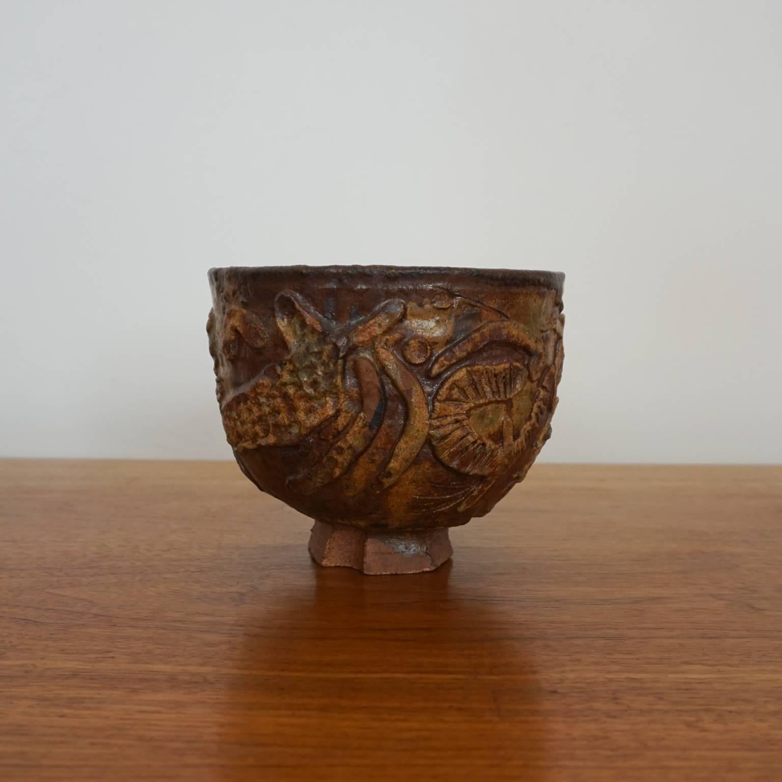 Ceramic bowl by Robert Arneson. The applied design is a great example of the artist's transition into Funk. Signed. 

Robert Arneson was a California artist and professor of ceramics at UC Davis for nearly three decades. He is considered the