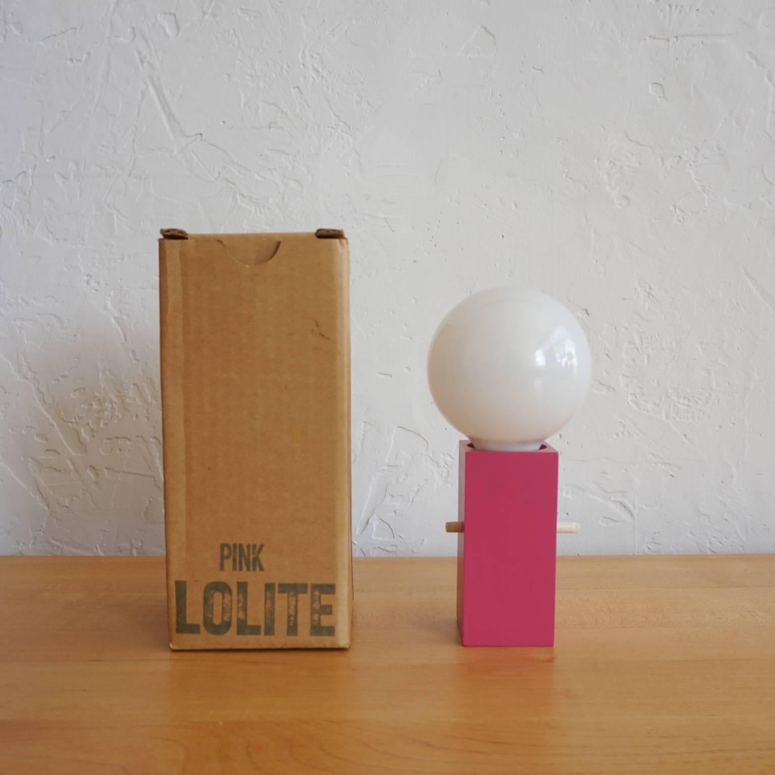1960s lamp designed by Bill Curry for Design Line. Complete with original packaging. The base is pink painted wood. It appears to be unused.