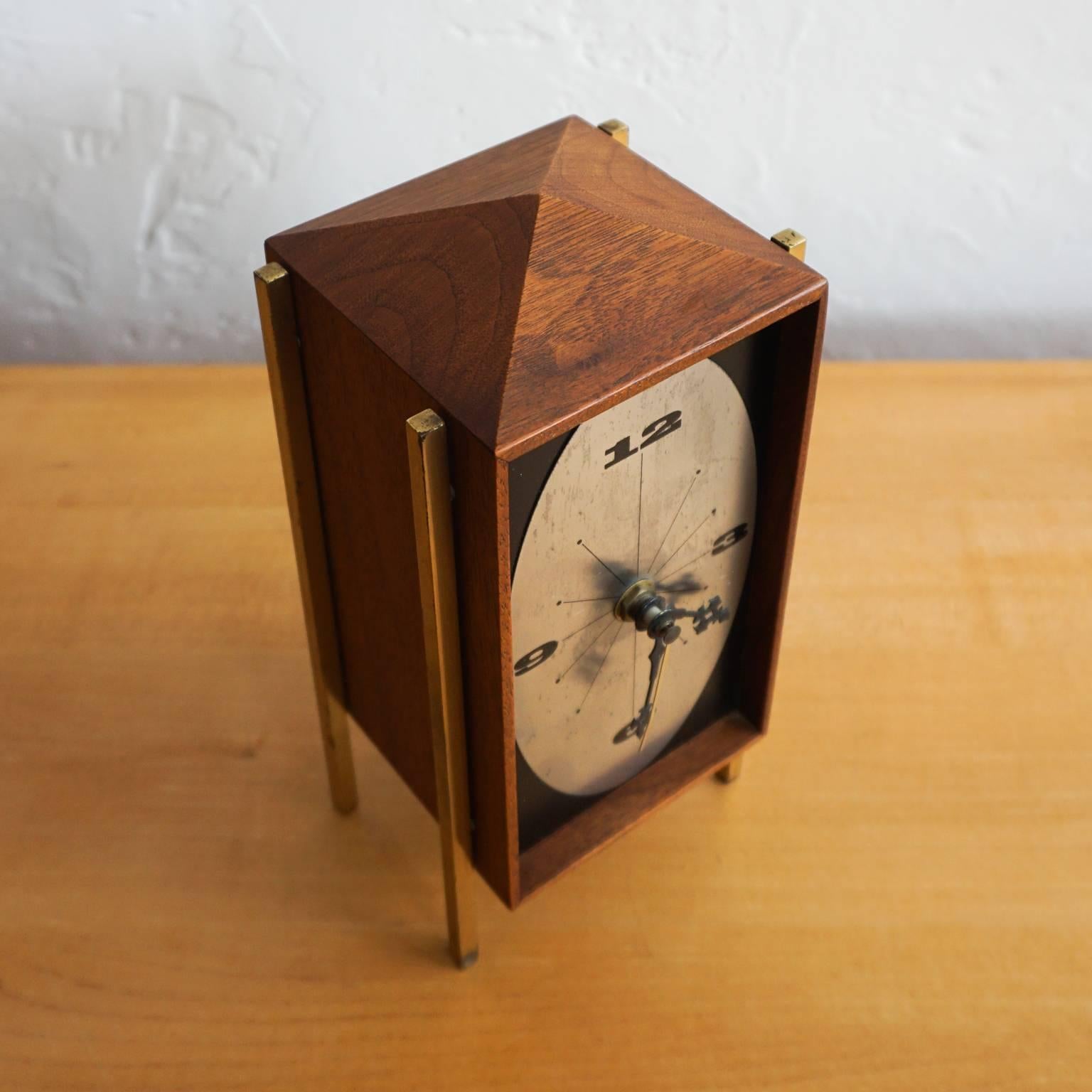 1960s walnut and brass table clock by Arthur Umanoff for George Nelson and Associates. Produced by Howard Miller. Battery operated.