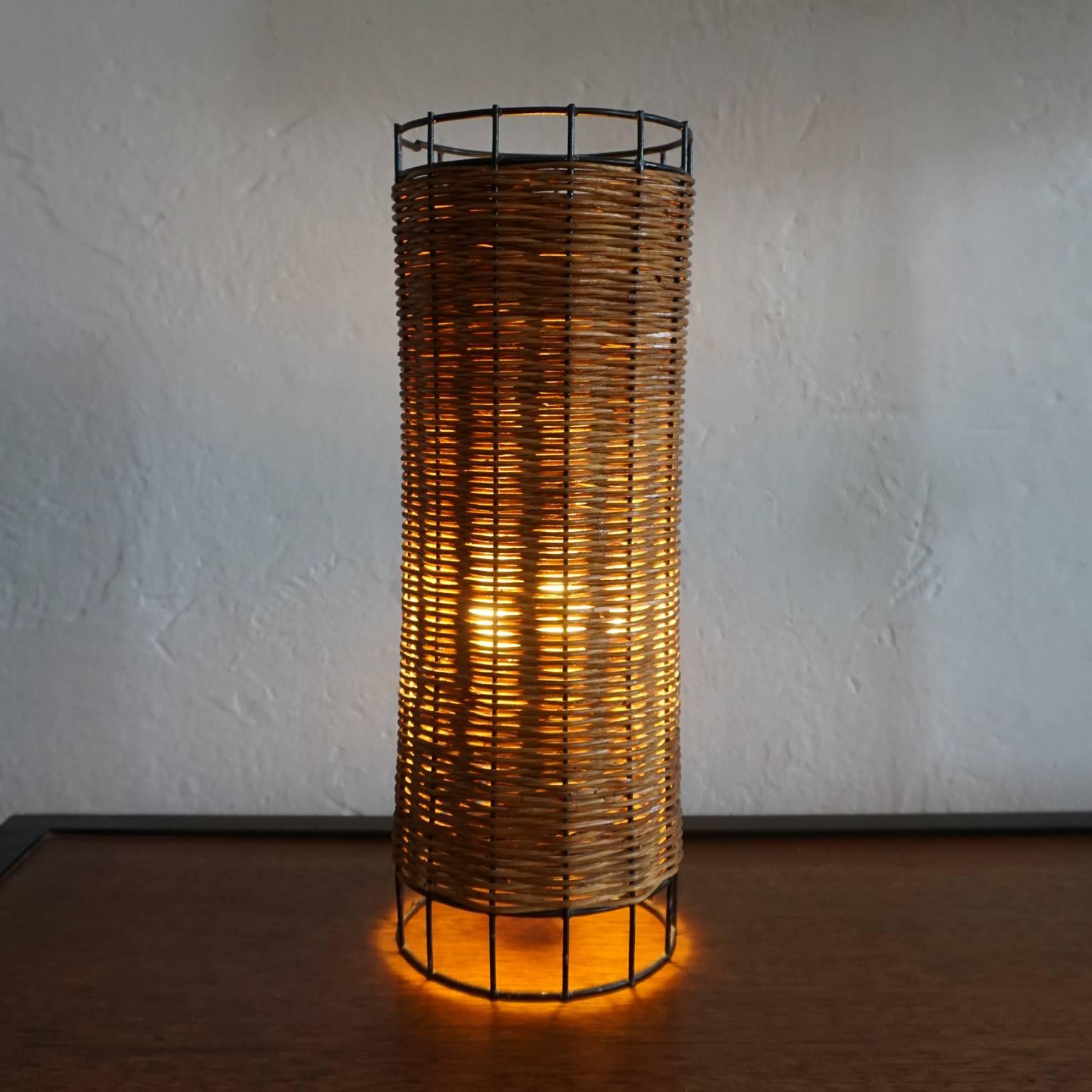 1950s cylinder table lamp made of iron and reed.