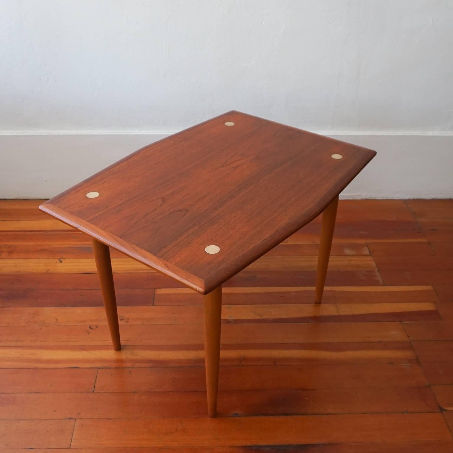 Pair of teak tables with brass inserts and angular sides, by DUX of Sweden, 1950s.