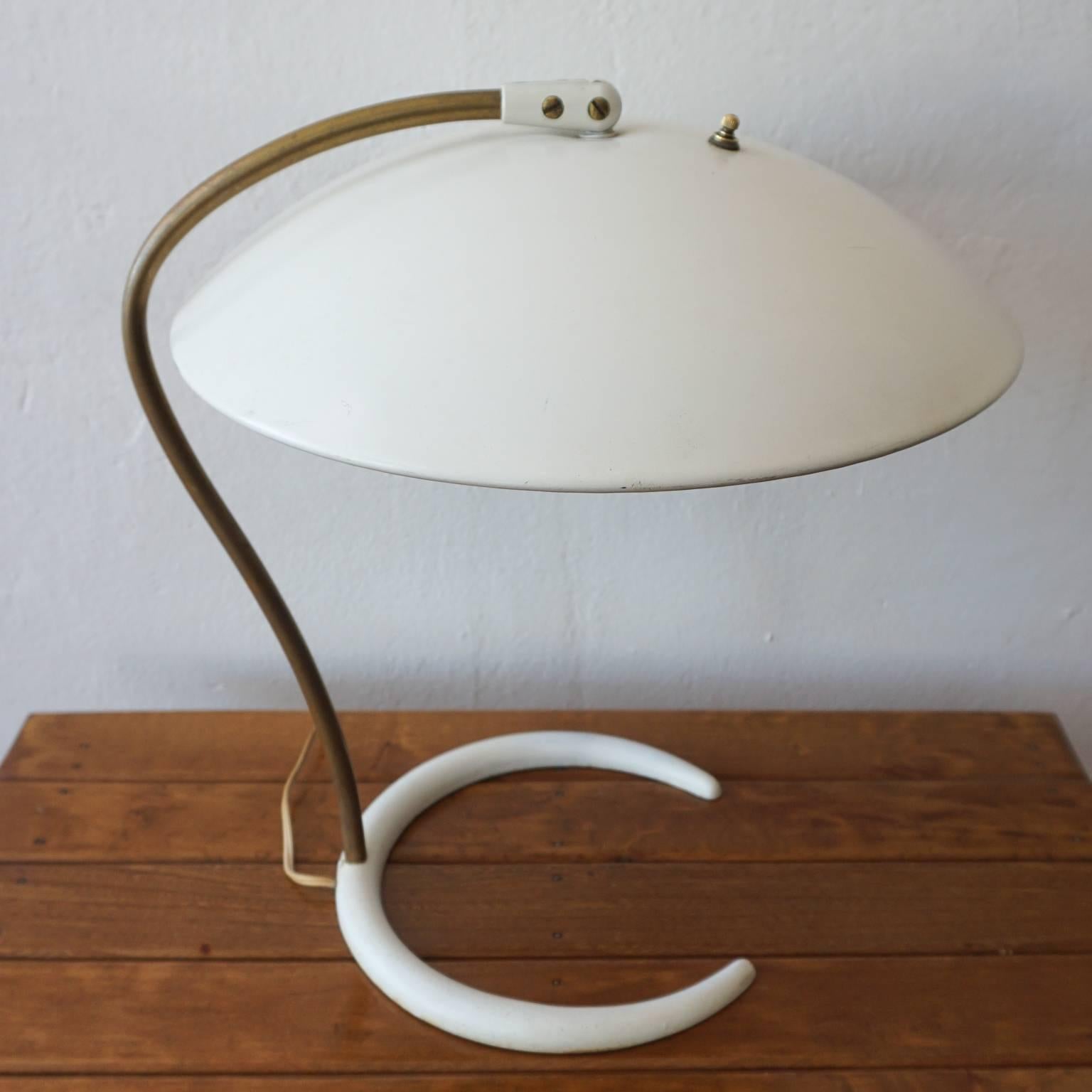 Dual bulb adjustable saucer shade by Gerald Thurston for Lightolier. Cast iron crescent base, brass tubing and enameled metal shade.