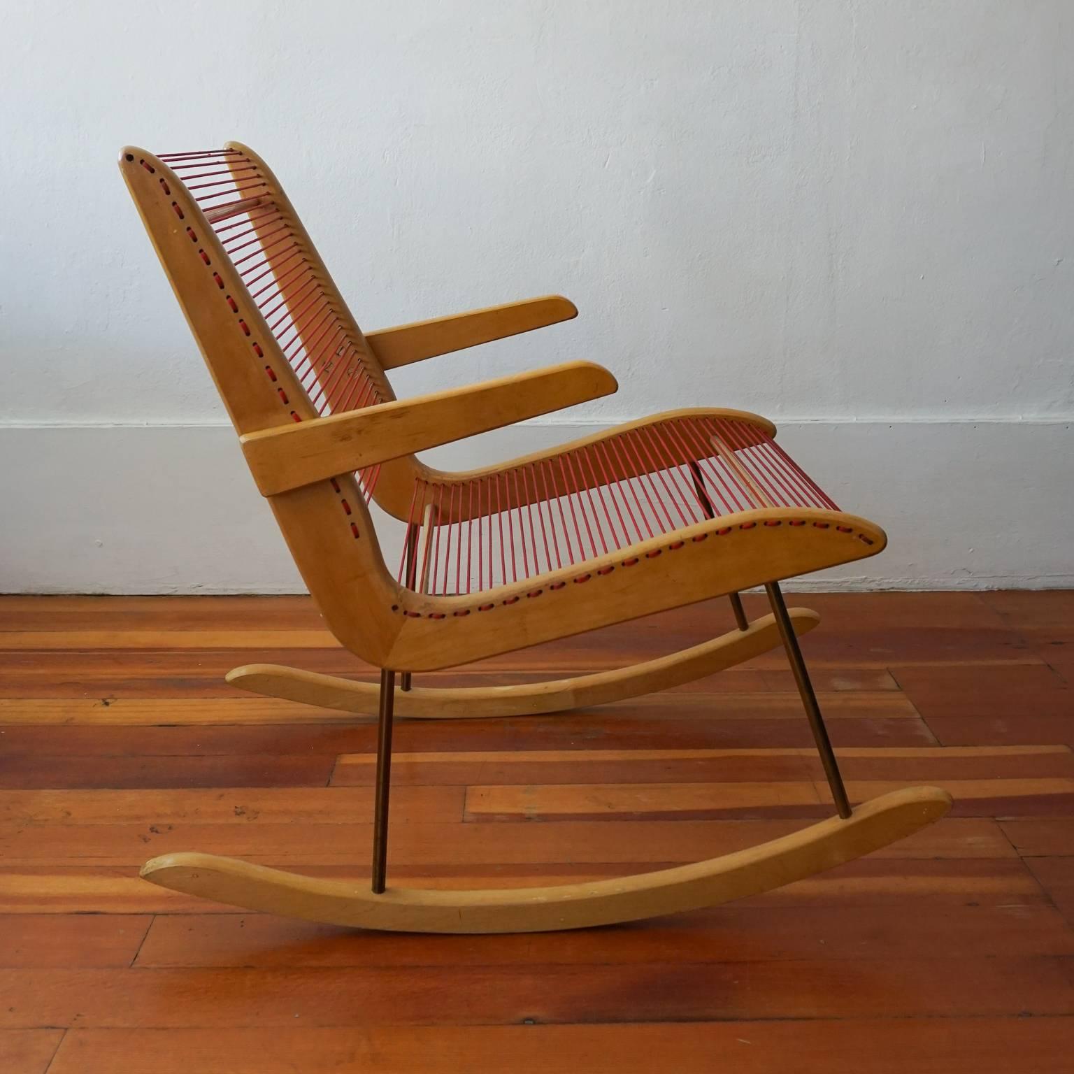 Modernist string rocking chair by Carl Koch for Tubbs of Vermont. Great Minimalist design by the Bostson architect. Simple wood frame, red nylon cord, and brass legs. Early 1950s.
