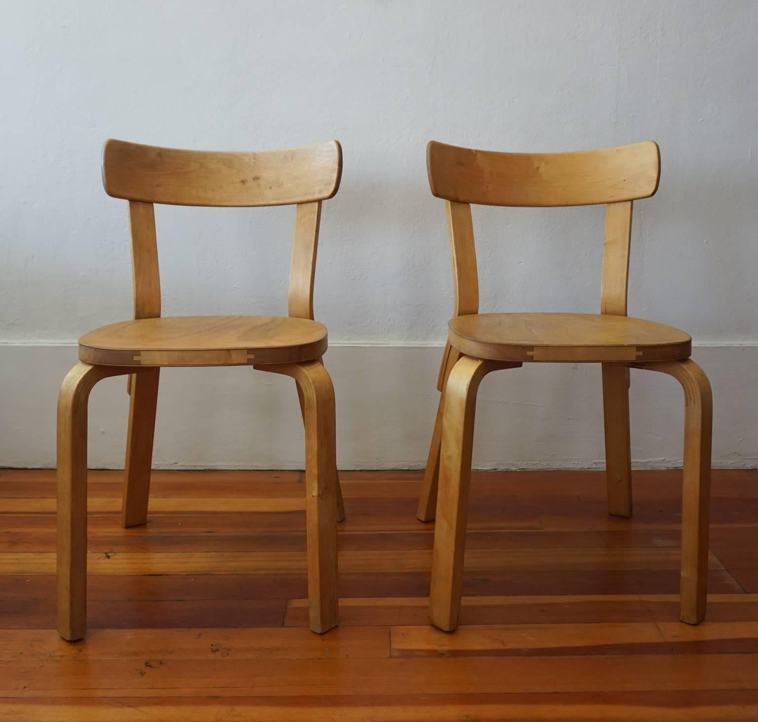 Early bentwood pair of chairs, Model 69 by Alvar Aalto for Artek. Birch, with brass fittings, 1935.