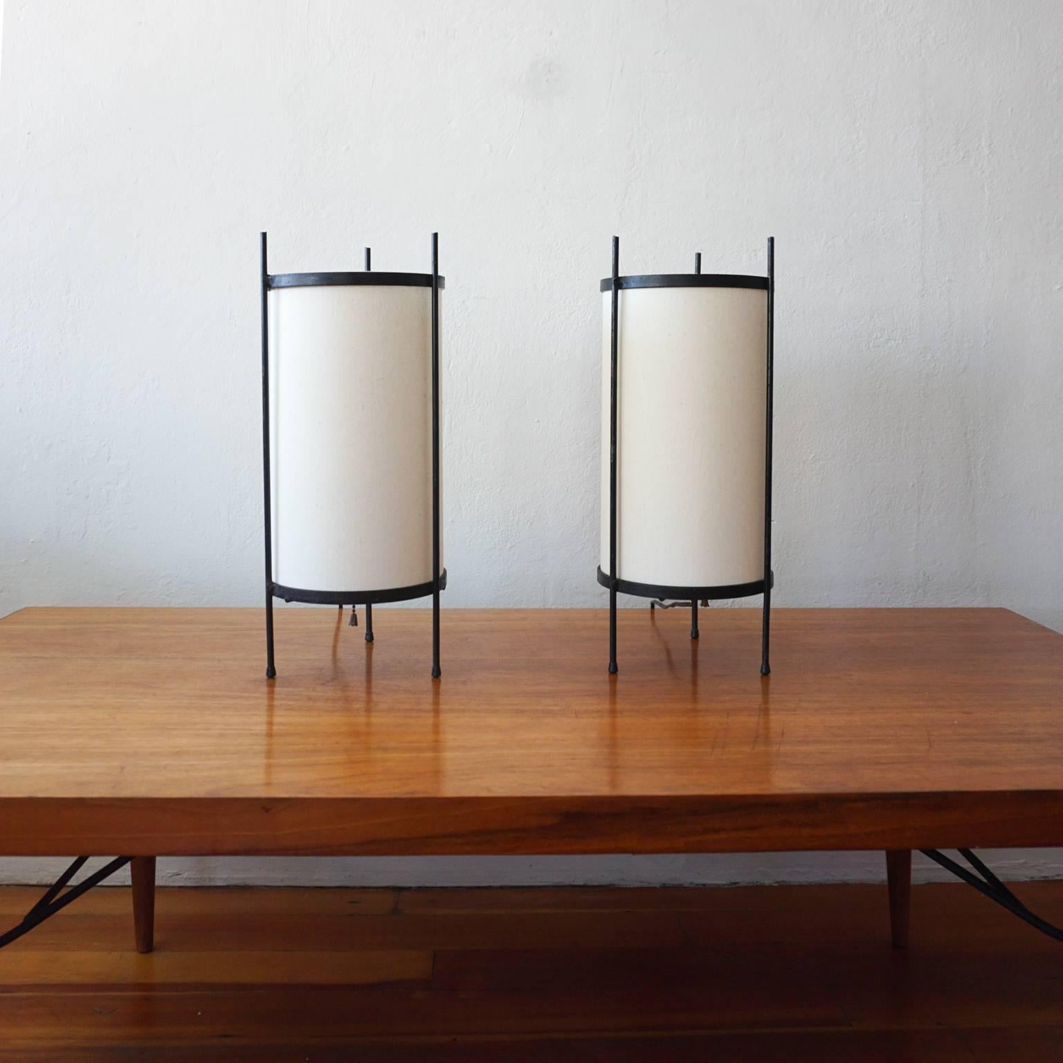 Pair of iron cylinder lamps with new natural linen shades, 1950s.
