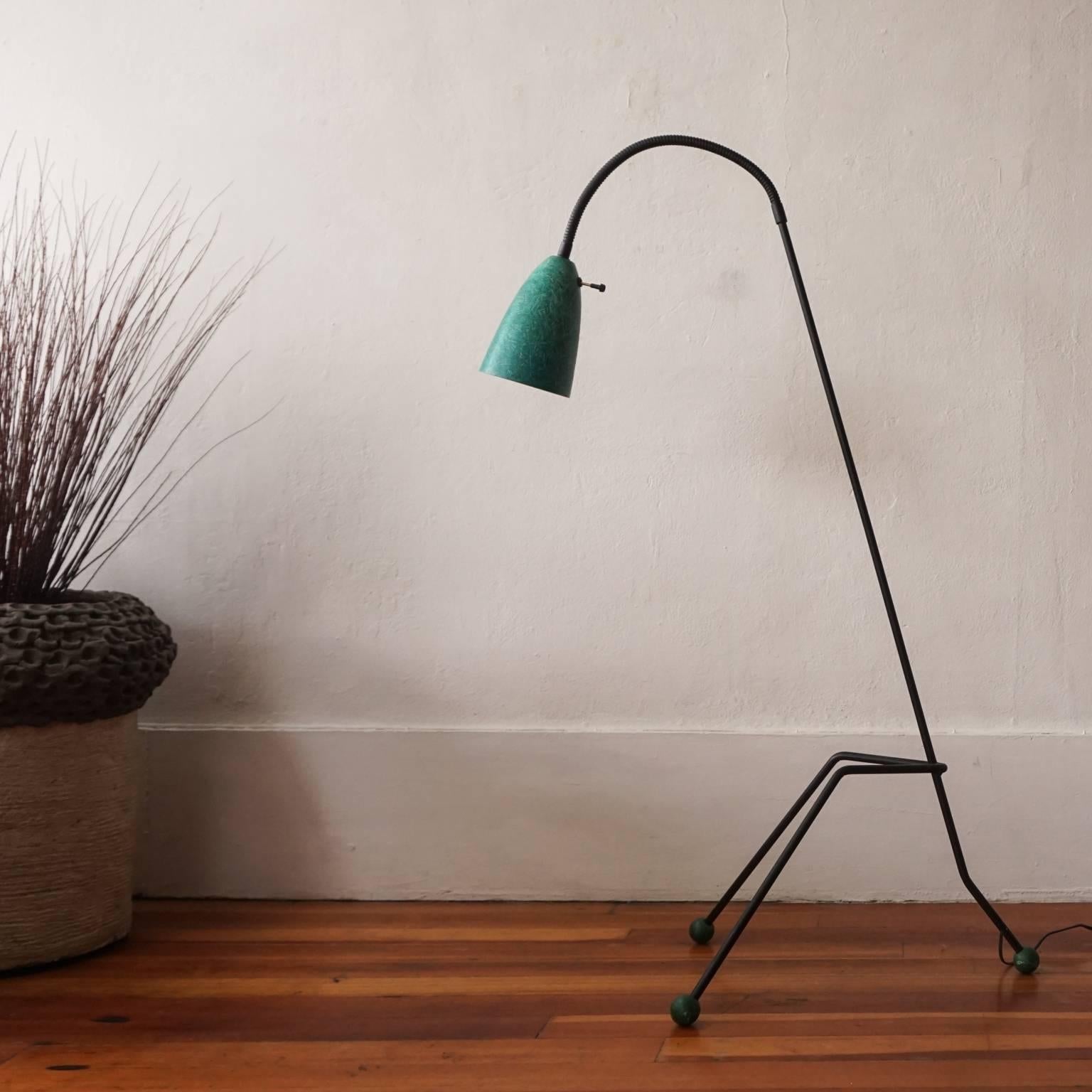 1950s, iron and green fiberglass floor lamp. Adjustable shade and wood ball feet in green.