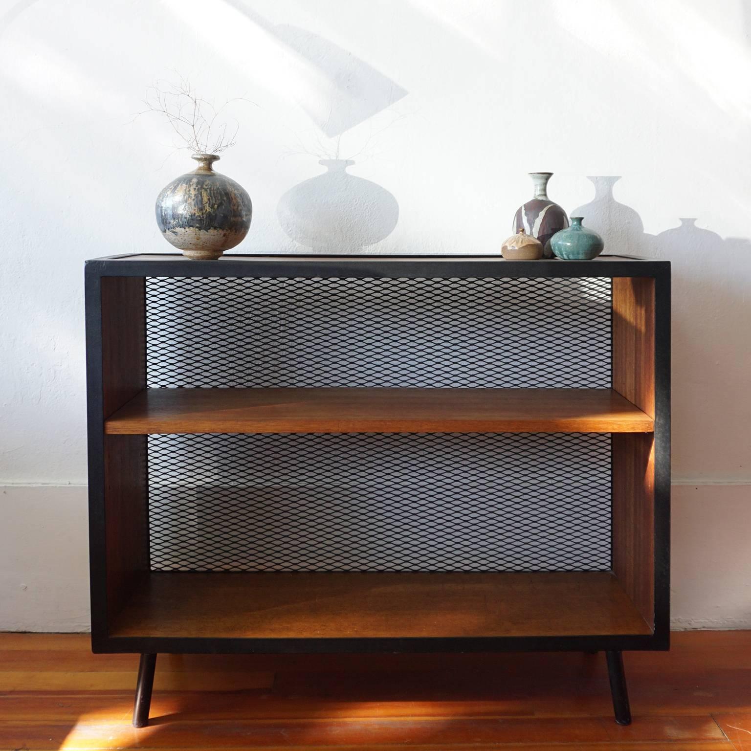 Philippine mahogany and steel bookcase by Los Angeles based Vista Furniture Company. Expanded metal backing with a solid steel frame. There are three positions to adjust shelves. Produced in the early 1950s.

Extremely sturdy construction.