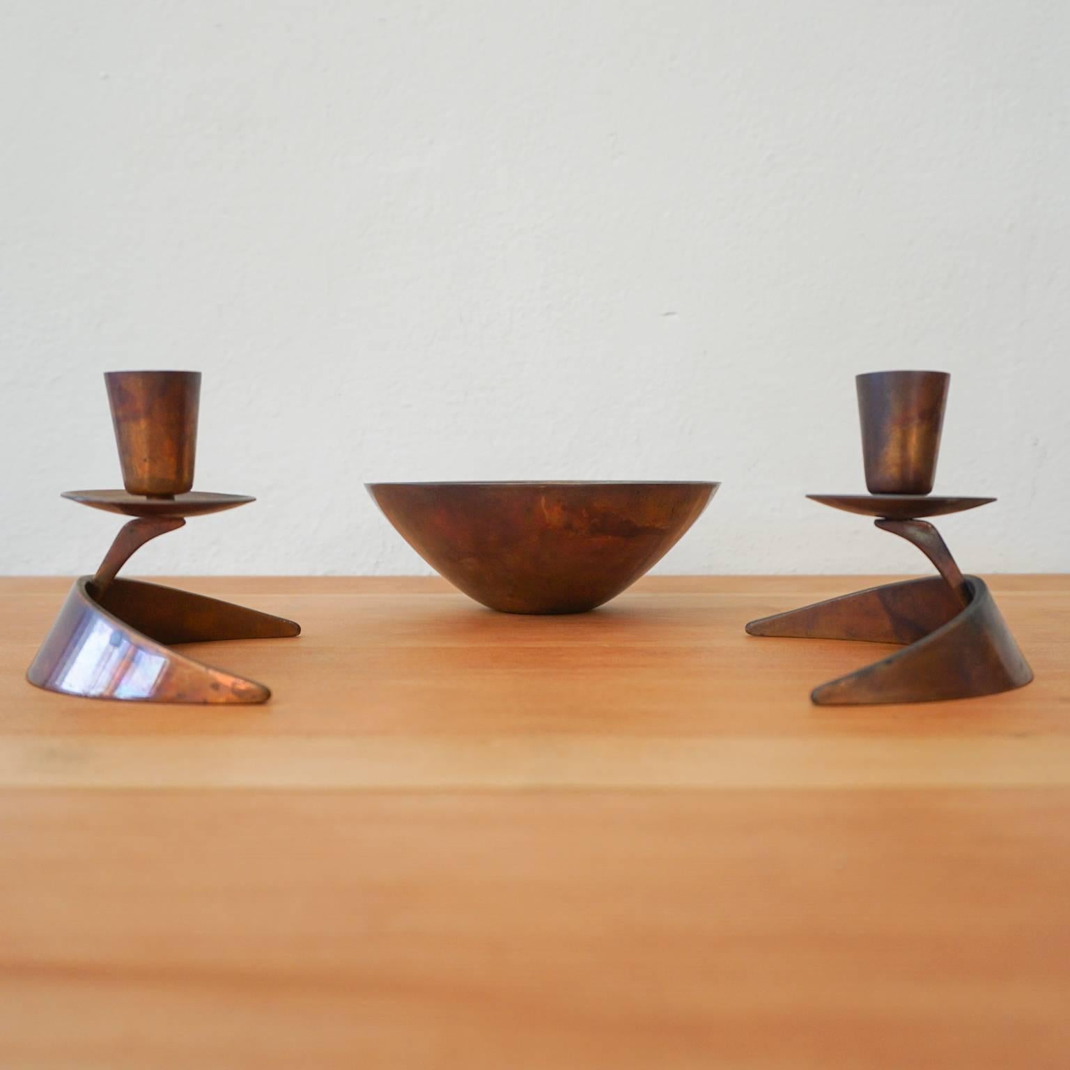 Solid bronze bowl and candlesticks by Ronald Pearson for Metal Arts Co. Rochester, NY. Signed with a stamp.

Measures: Bowl 5.75 D x 2