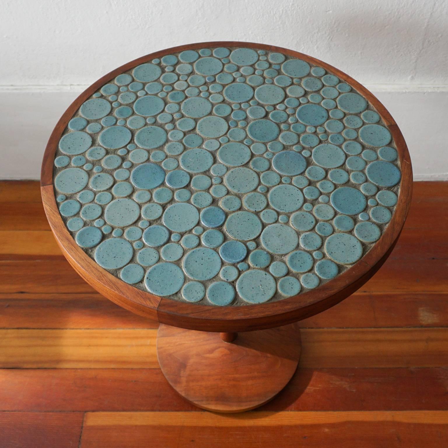 Side table constructed of solid walnut, with a coin ceramic tile top in a blue glaze. Jane and Gordon Martz for their company, Marshall Studios, 1950s.
