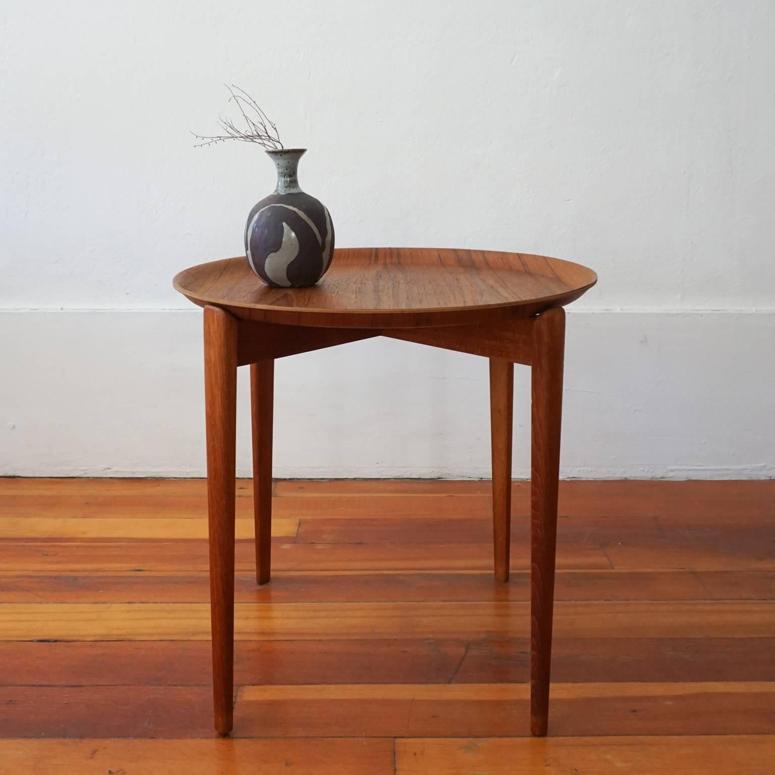 Removable top tray table. Molded teak top and solid teak base. Made in Sweden, 1950s.