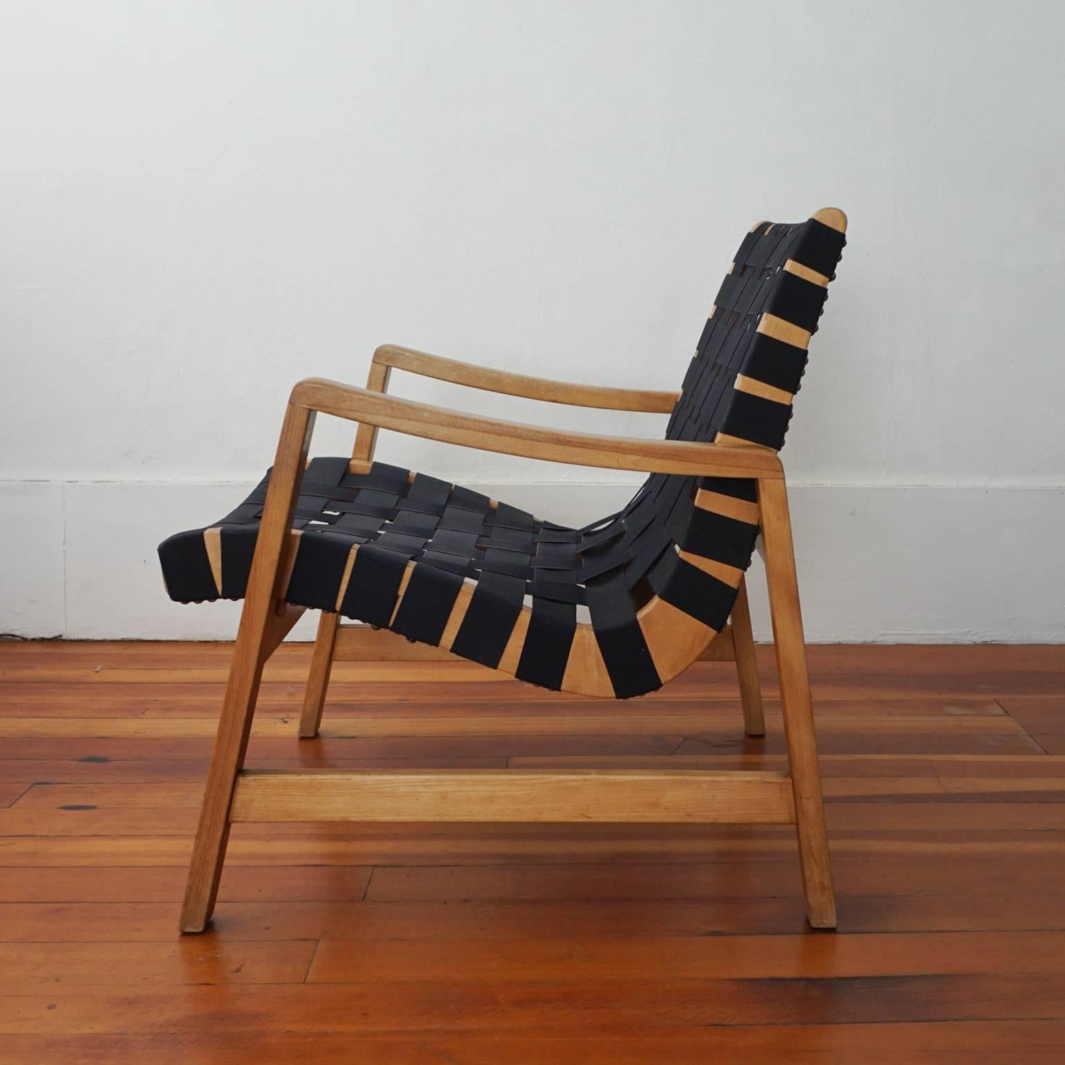 Knoll 652 webbed lounge chair deigned by Jens Risom for Knoll. Black cotton straps and maple frame. Early Knoll International label.
 