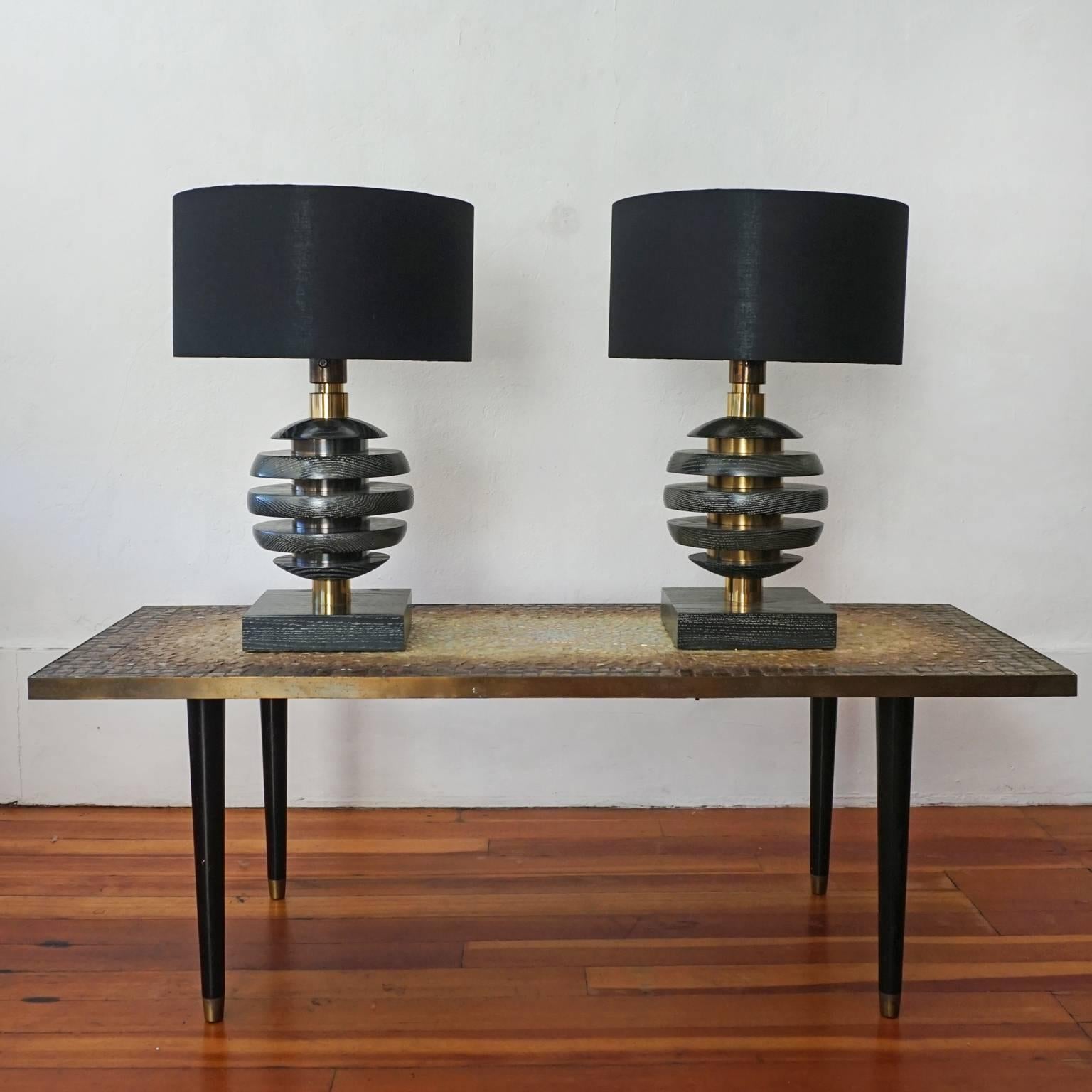 A pair of black cerused oak lamps from the 1940s. Brass hardware and milk glass inner shades. High quality construction. New black linen shades. 

Measure: Shades 15