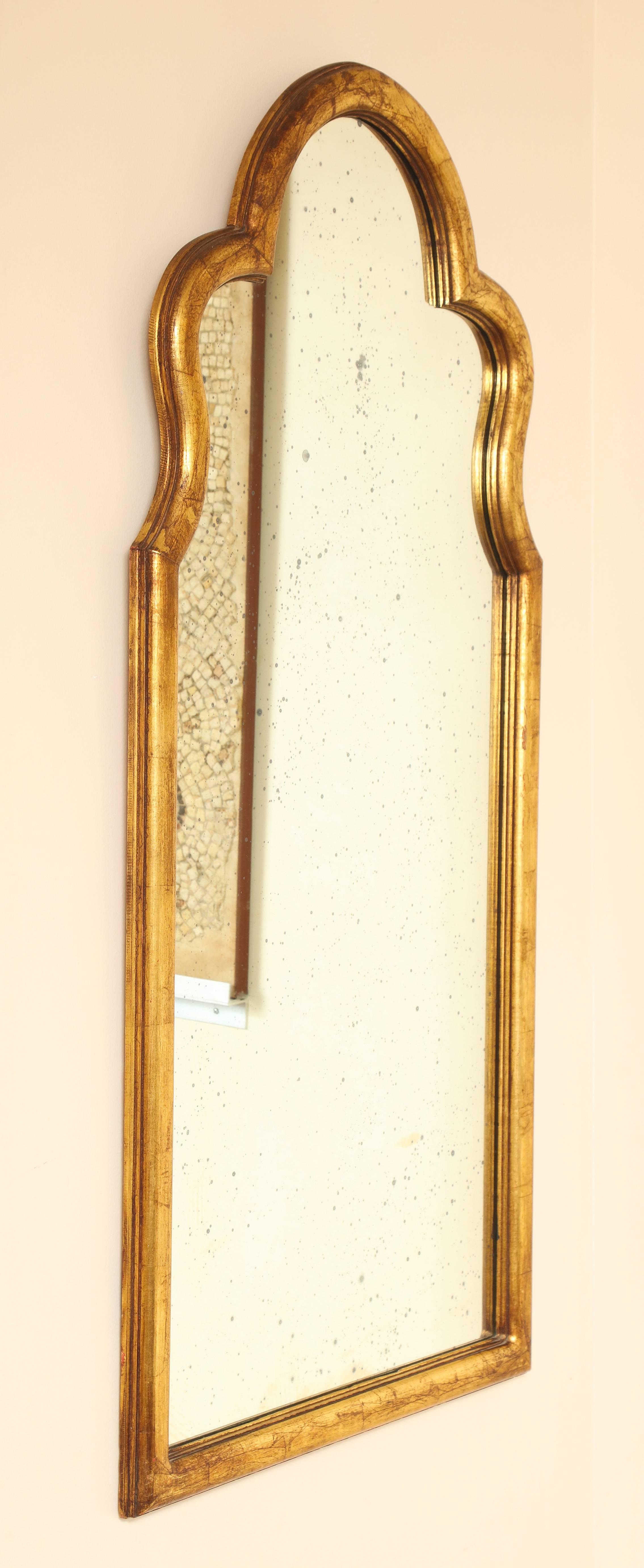 A classically shaped gilded Queen Anne inspired mirror frame with original antiqued mirrored glass.