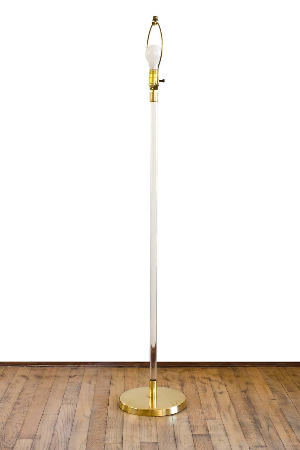 A modern classic: 1970s standing floor lamp with cylindrical Lucite stem supported on a brass 9 1/2