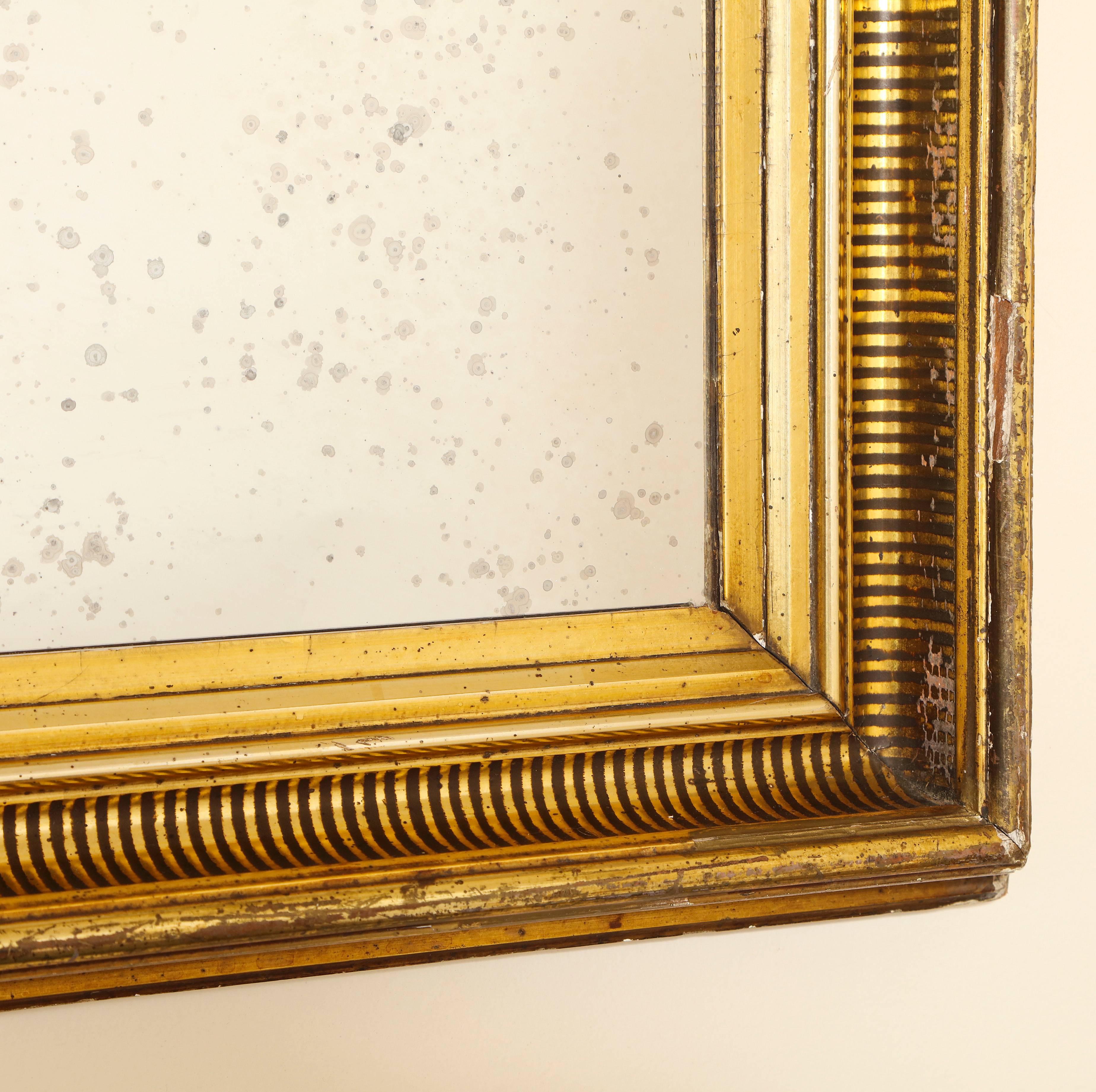 A dramatic gilded (original) mirror frame with painted black striped molding and antique glass. Can be hung horizontally, as pictured or vertically.