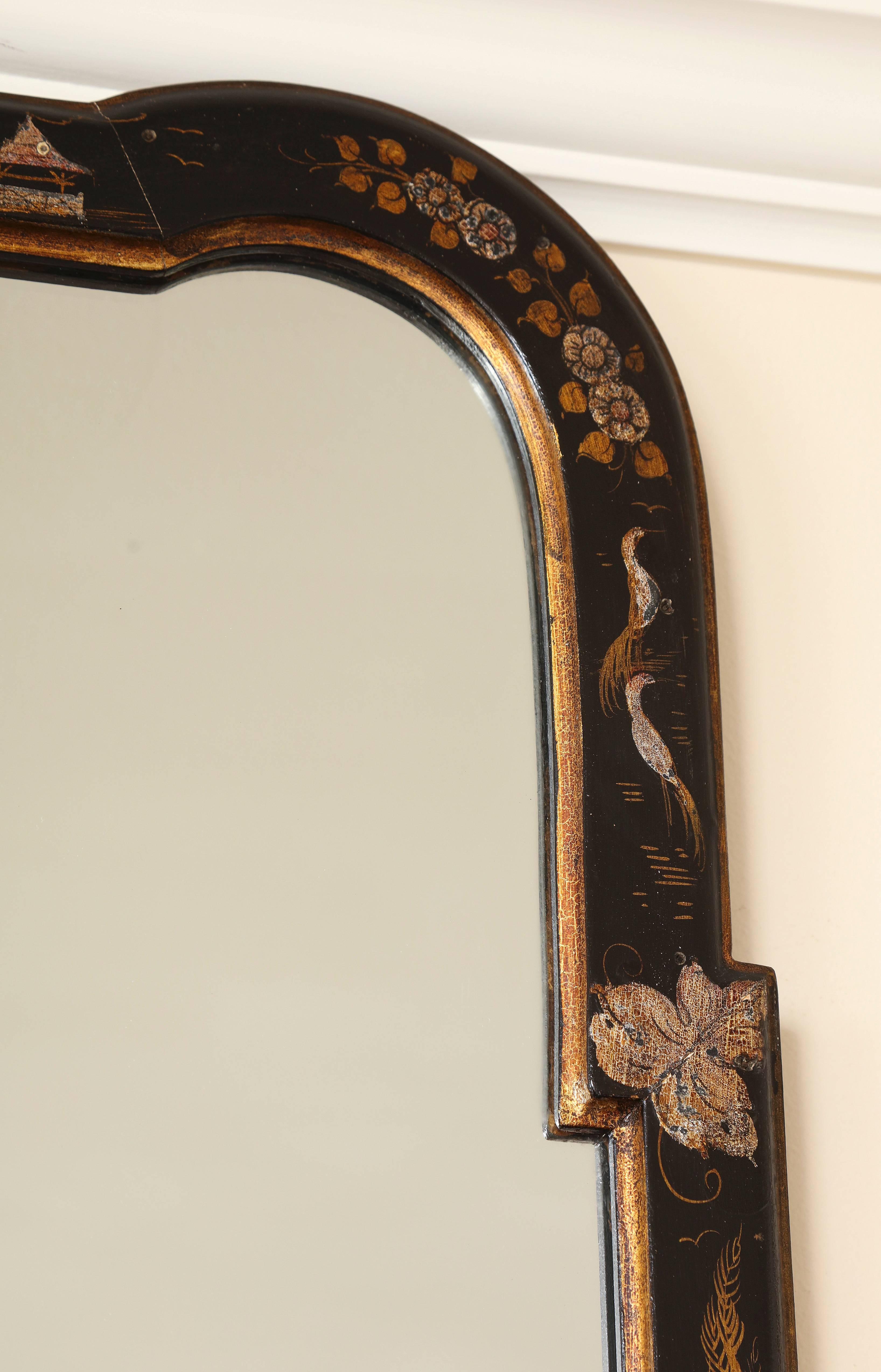 A chic and classic Italian vintage Mid-Century Modern chinoiserie wall mirror with hand-painted gilt and polychrome decoration on a black background. All original and in excellent condition; with its label and inventory number on the back.
