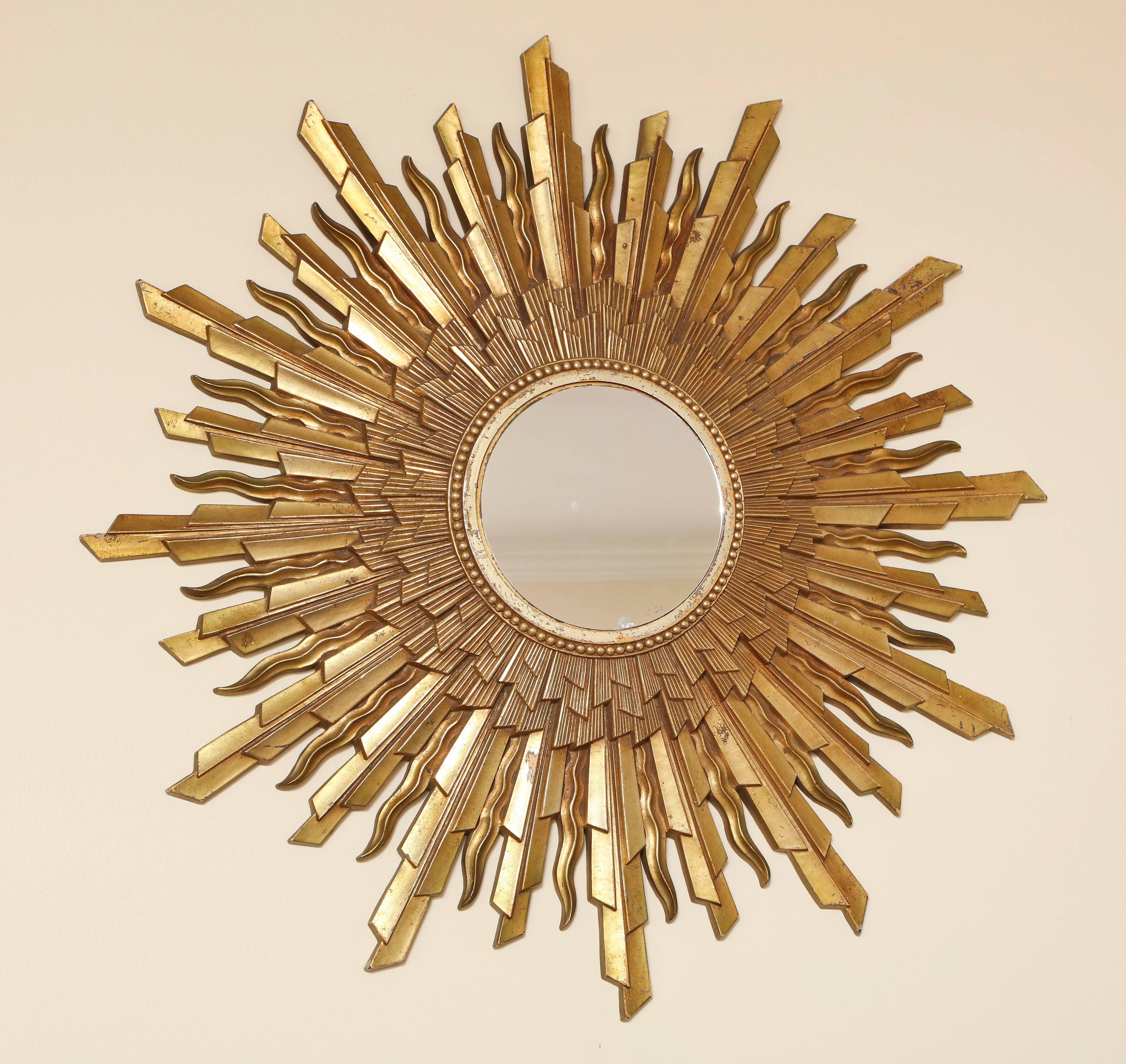 A vintage Mid-Century Modern starburst, sunburst framed mirror; large gold composite wood of molded design. Stamped, Burwood Products. 
Size: 28