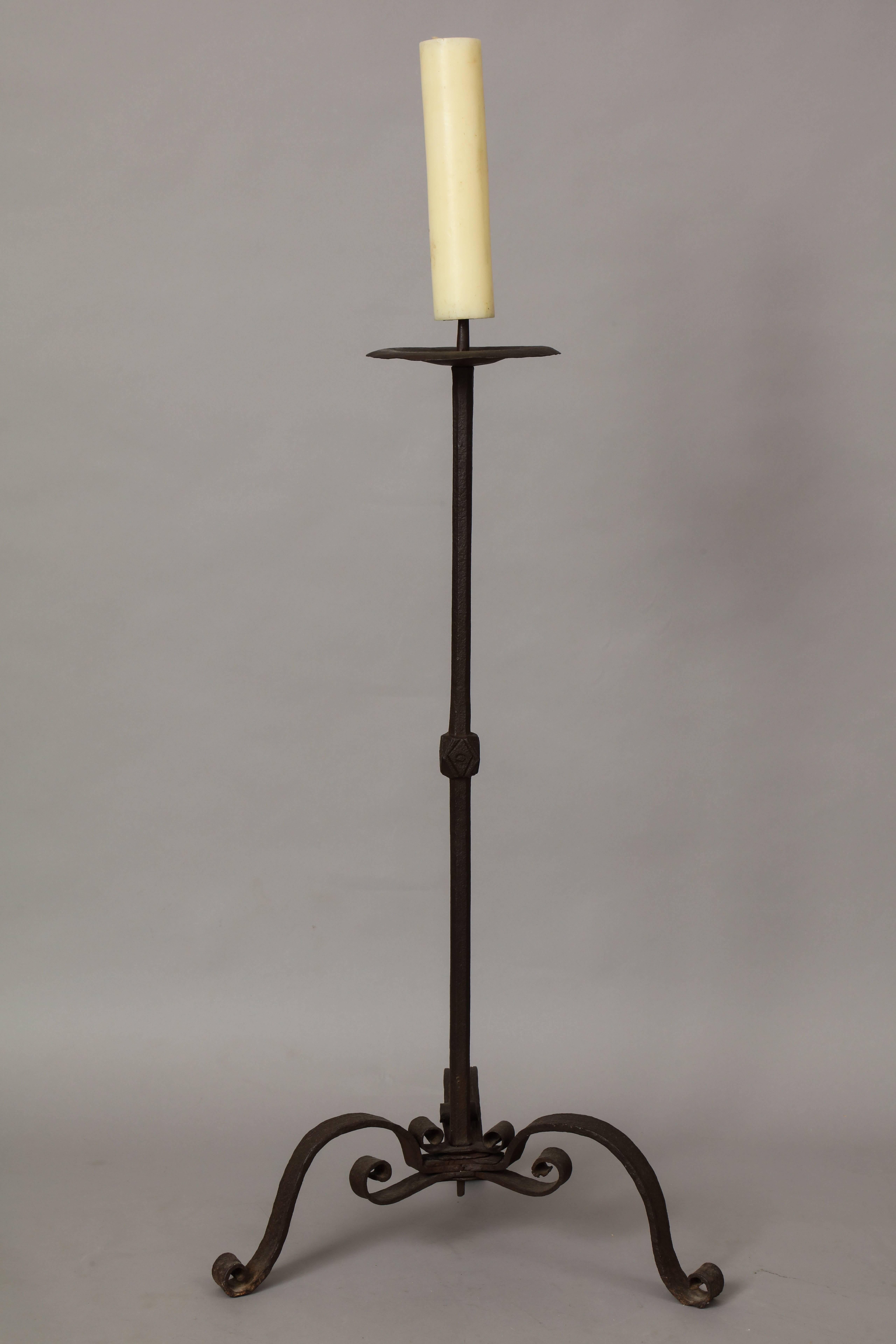 A single candle wrought iron candelabra with tripod base and faceted knob on shaft.
Italy, 15th century.
Size: 55 ̋ high x 24 ̋ diameter.