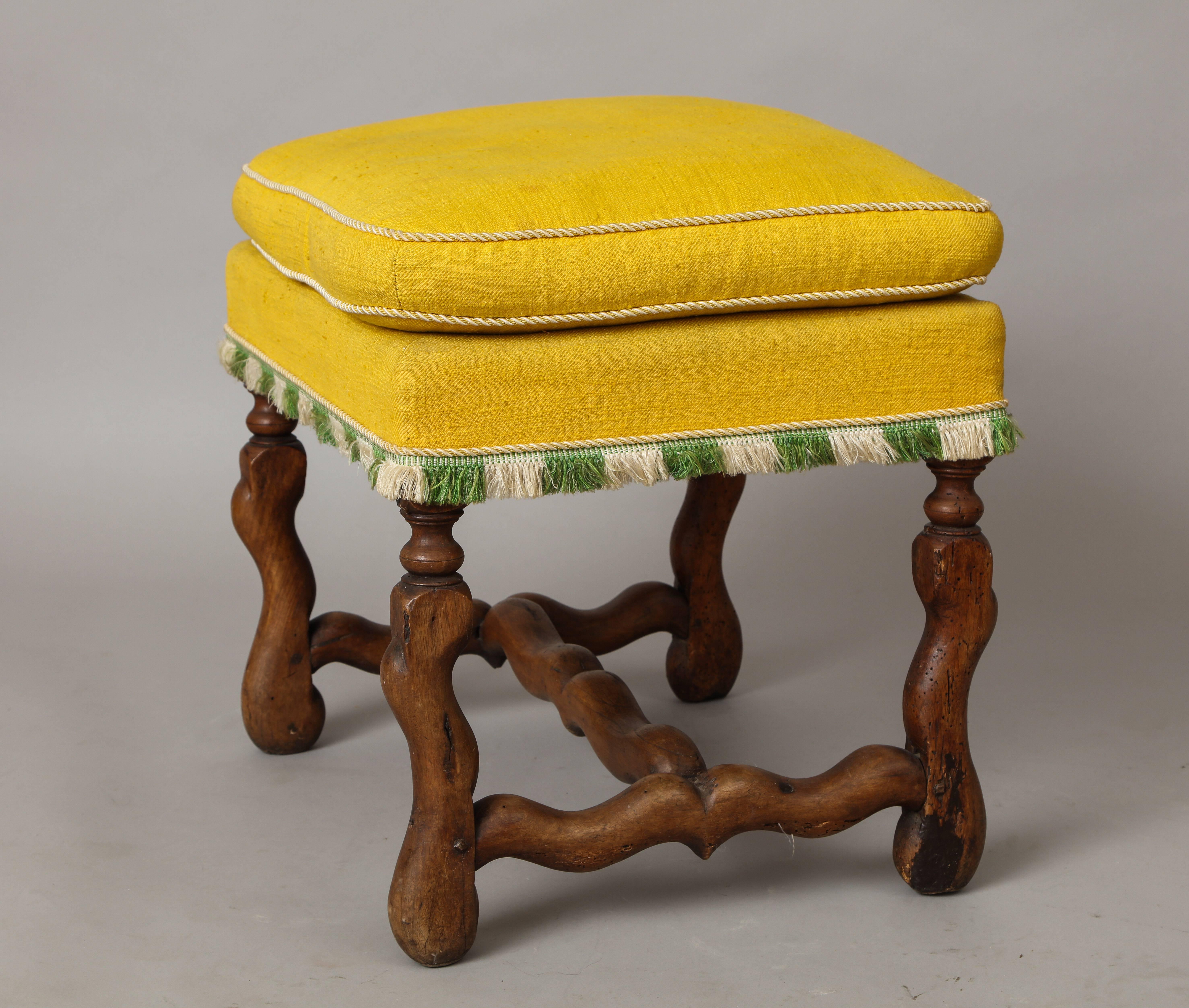 A French Louis XIII period walnut stool with ‘Os de mouton’ legs and stretcher, upholstered in whimsical yellow cotton with green and cream tassels.
France, 17th century.
     
  