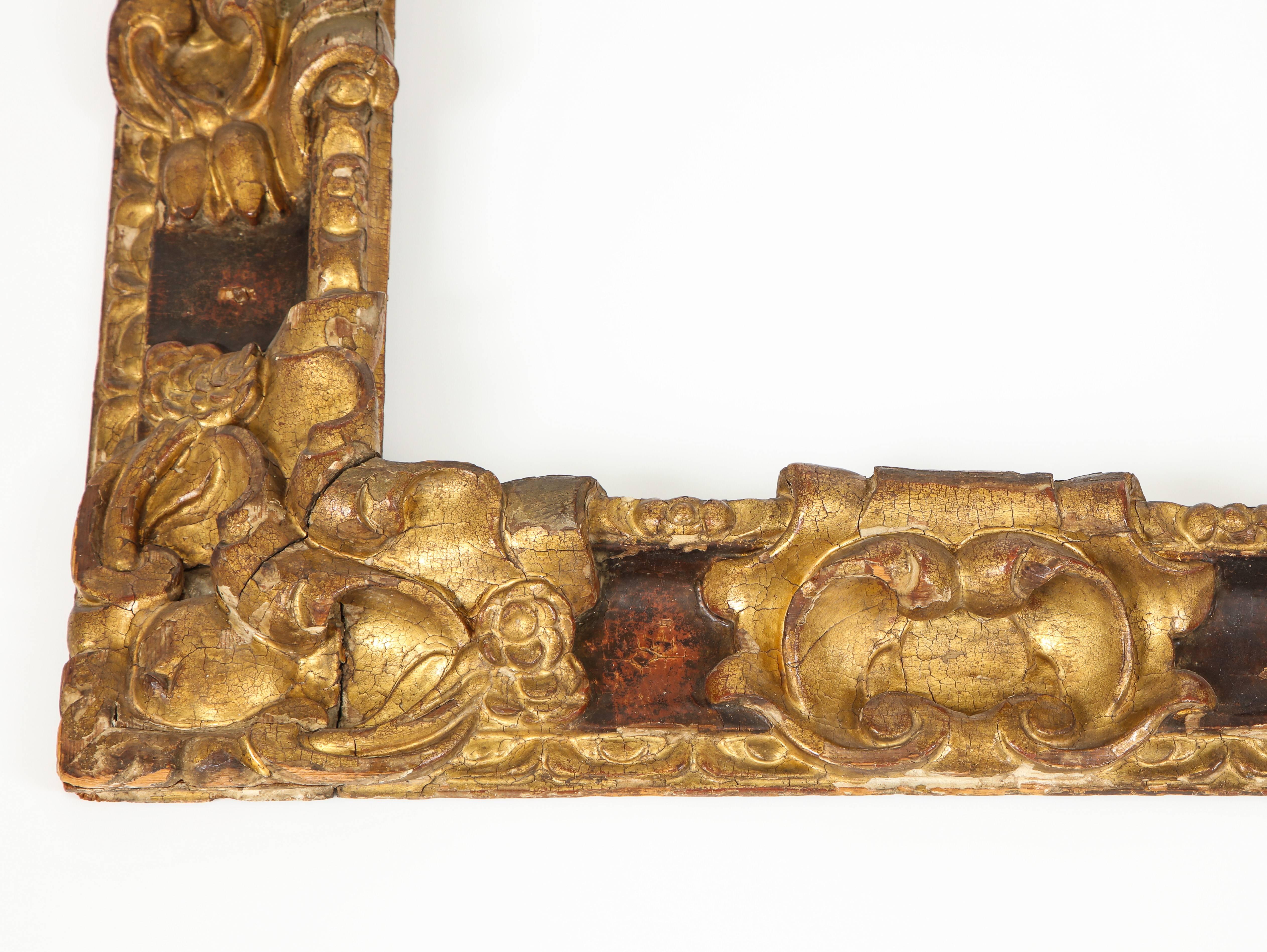 A carved gilt and black polychrome wood, reverse profile Spanish Baroque frame, circa 1670. 

Probably Seville, Spain, circa 1670
Size: 31 3/8” x 26 1/2”
View size: 22 7/8” x 17 1/2”

Molding width: 4 1/4”.

