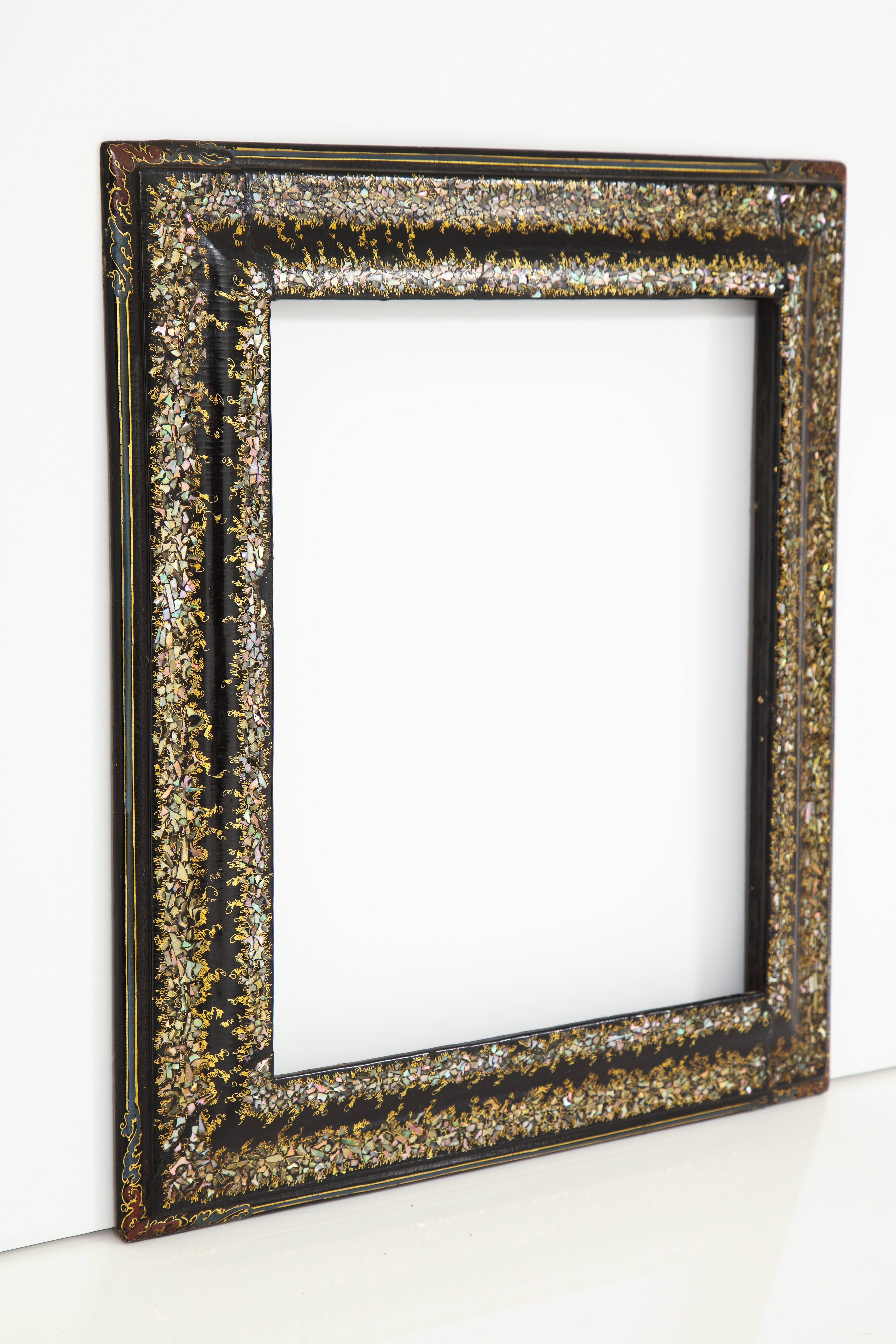 A French Napoleon III (Second Empire) papier mâché black painted, gilded and mother-of-pearl inlaid frame,
France, circa 1880
Size: 17 1/2" high x 16" wide x 1 1/2" deep.
    