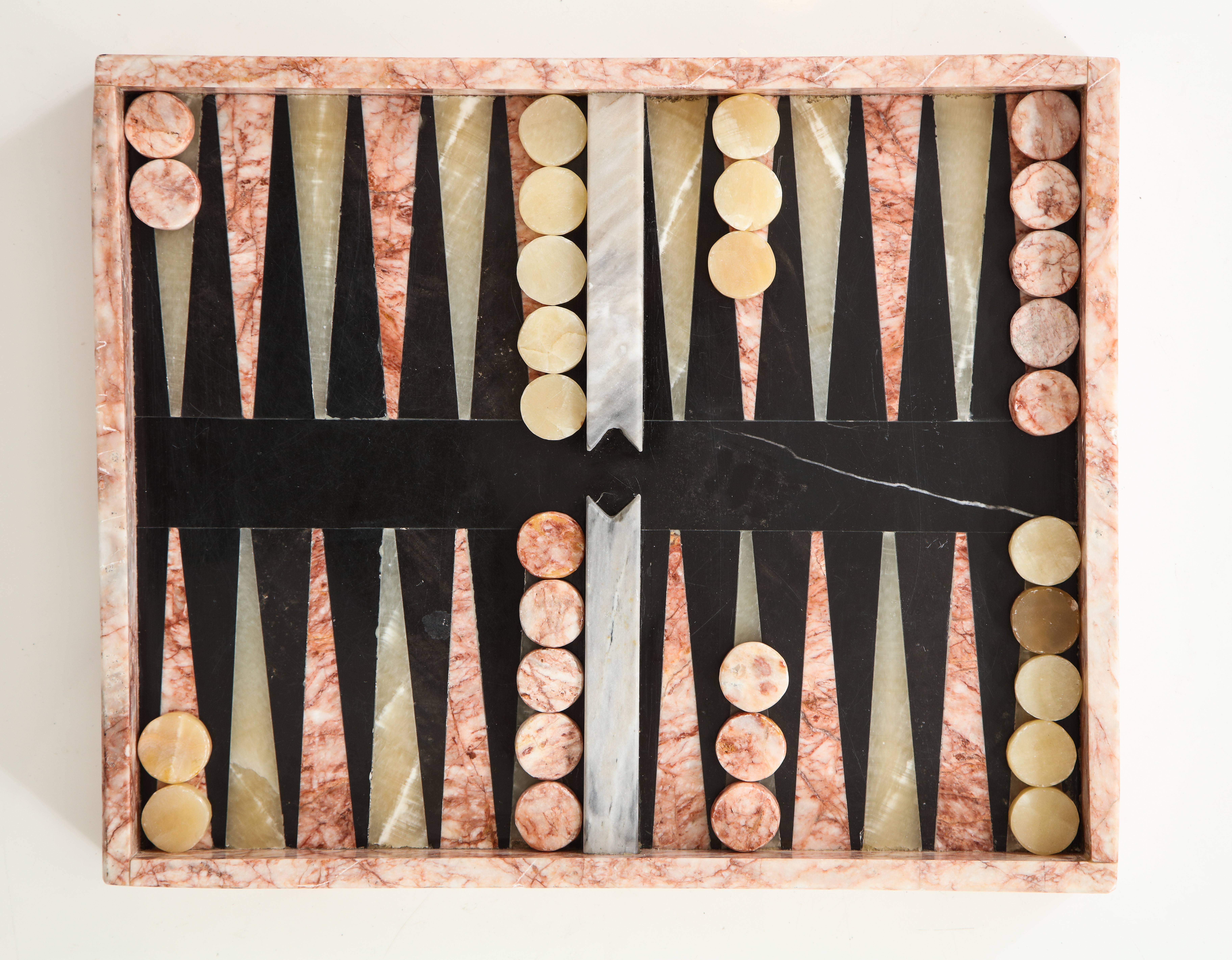 Play this beloved centuries old game in style!
An Italian inlaid marble complete backgammon set, the bottom with onyx inlay. This is a very heavy piece, approximate 25 lbs,
Italy, circa 1950
Size: 15" x 12" x 1 3/4" high.