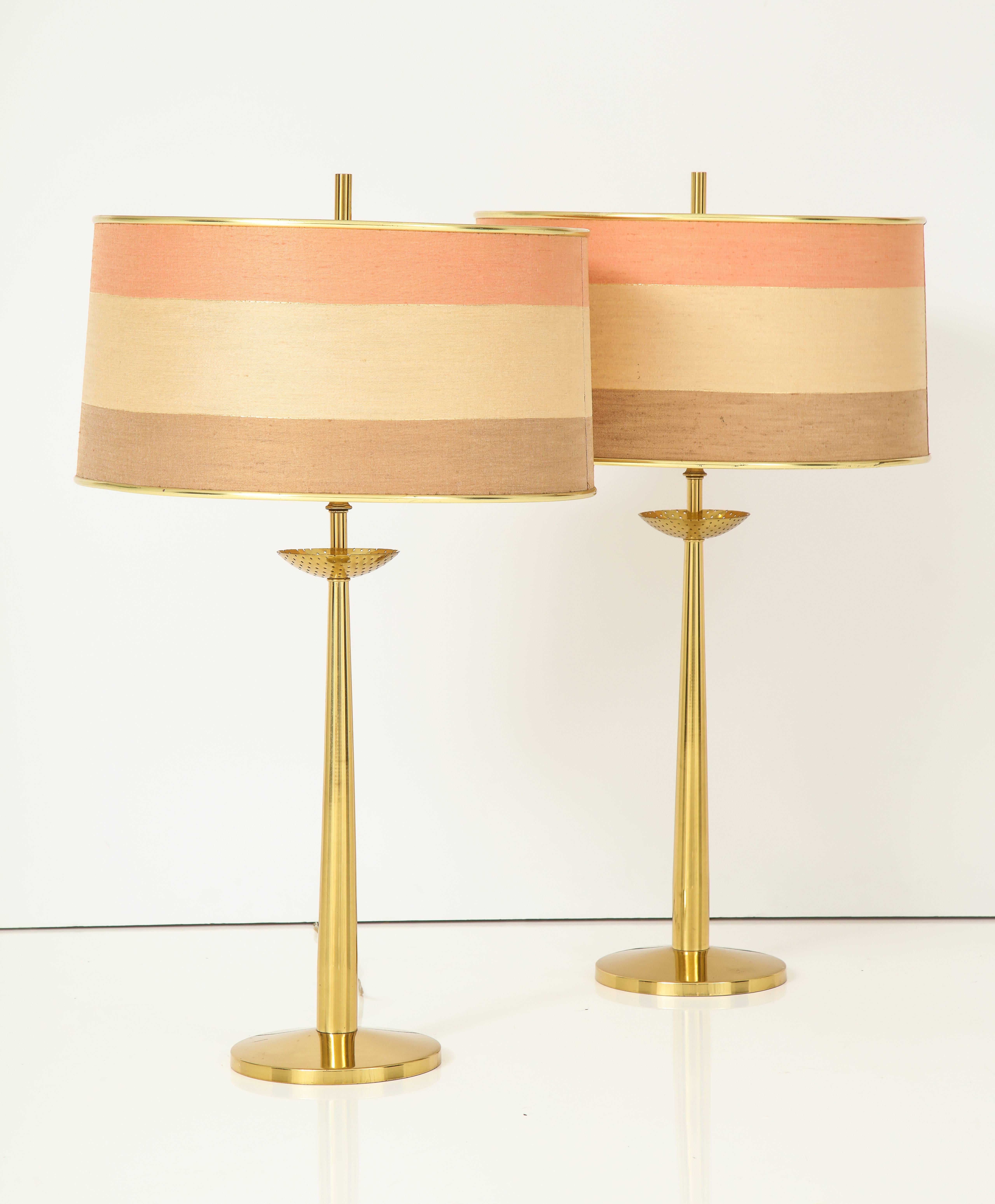 A pair of elegant and grand scale Rembrandt brass columnar table lamps with pierced bobeche, and beautiful original silk shades in pink, gold and brown stripe; with original brass finials. In excellent condition. 
With original Rembrandt labels,