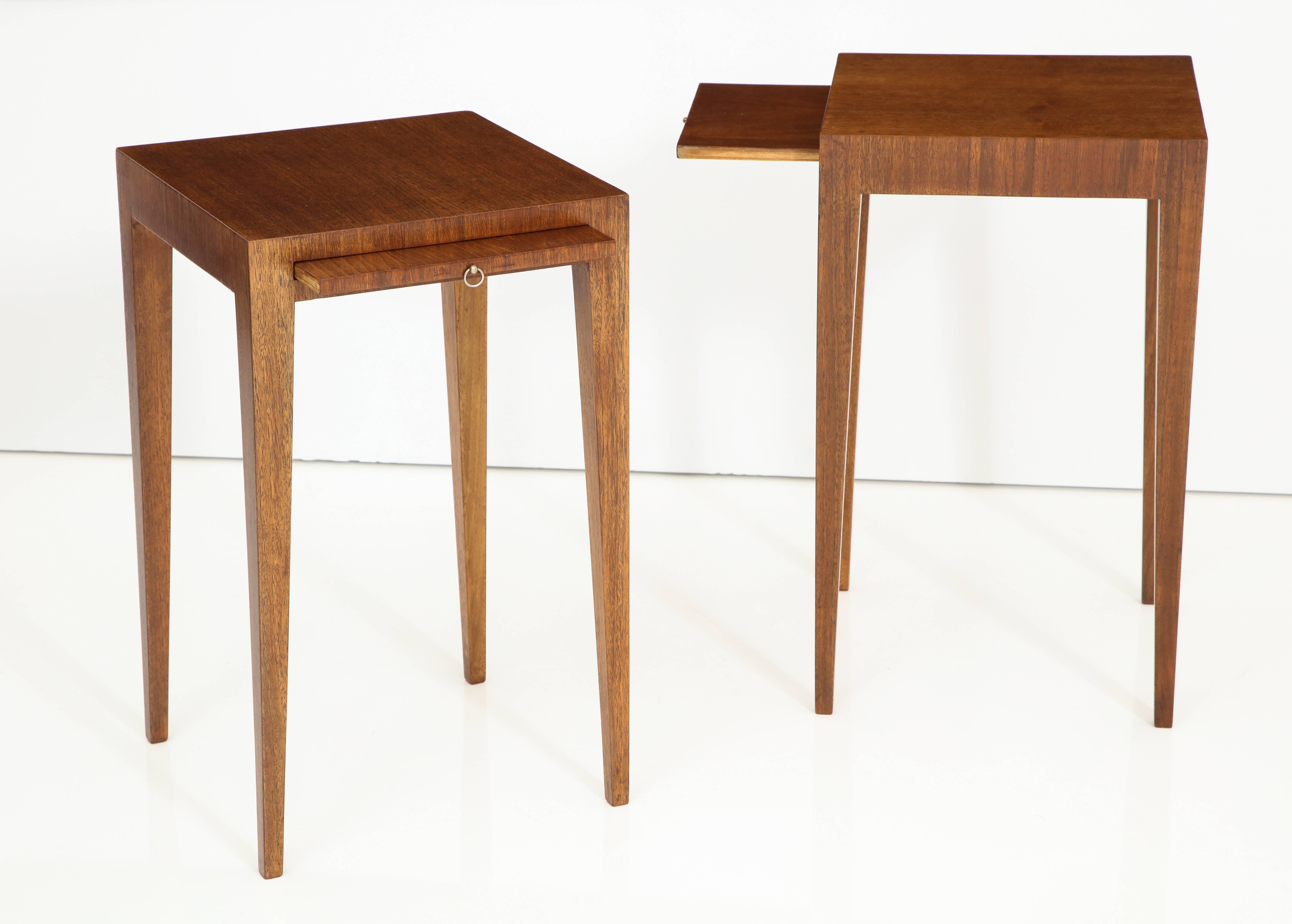 A pair of French Art Deco walnut side tables with elegant tapered legs, the front with a pull slide.
France, circa 1940
Size: 21