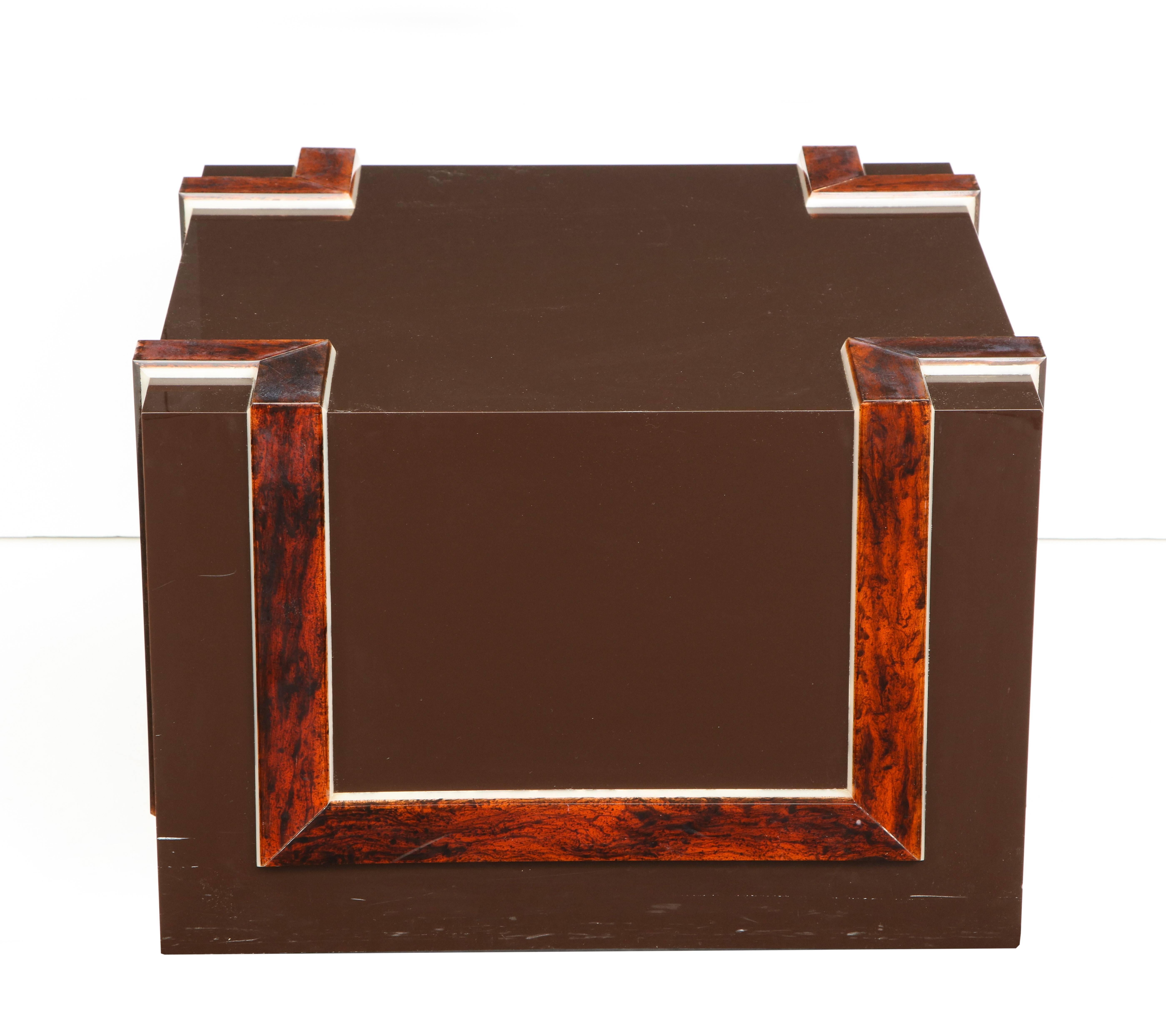 A 1970s modern chic chocolate brown cube form cocktail table with faux tortoise shell banded decoration on all corners and sides. 
American, 1970s 
Measures: Size: 16 1/2