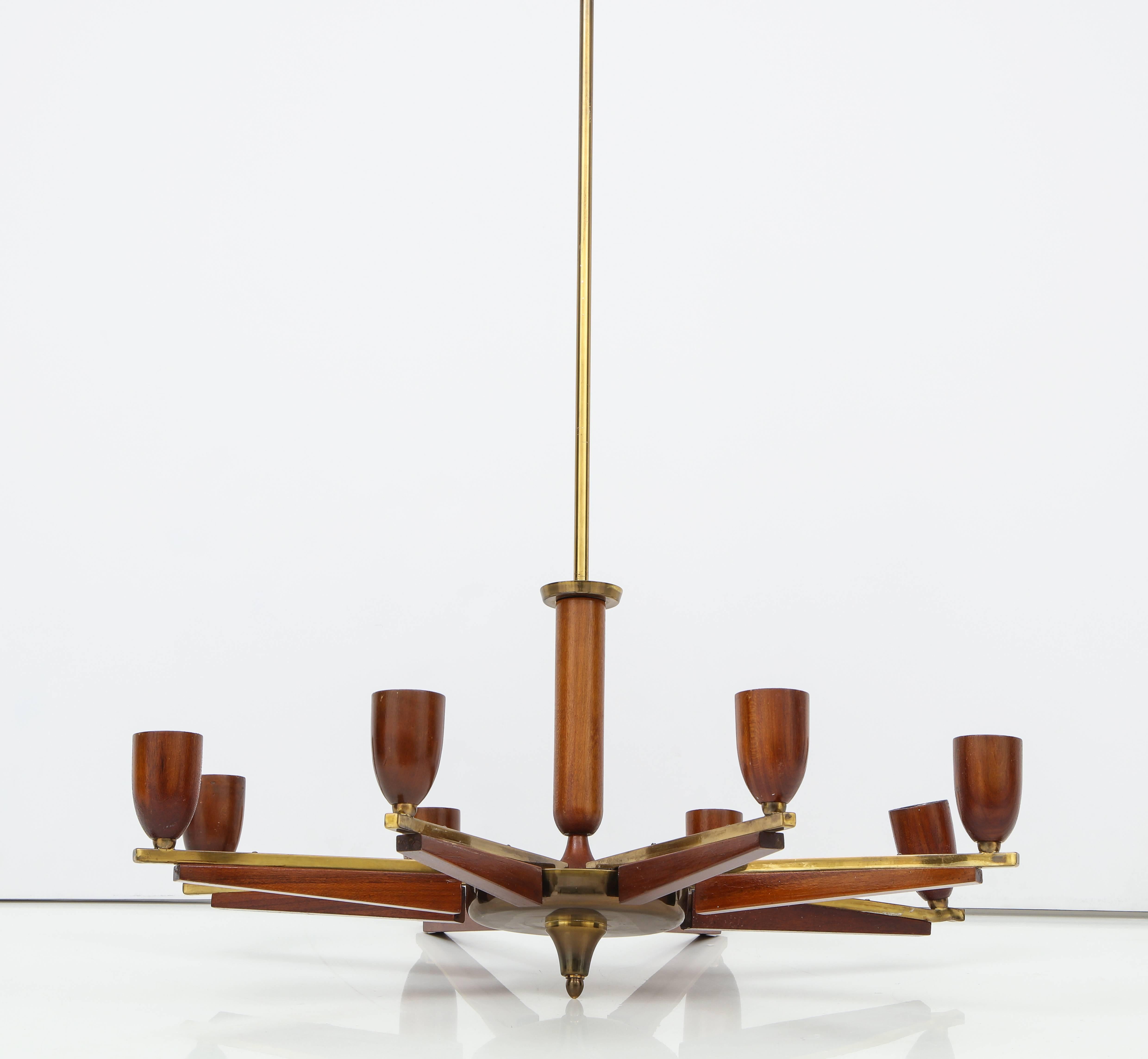 An elegant modernist Italian walnut and brass six-arm chandelier
Italy, circa 1960.
Size: 33
