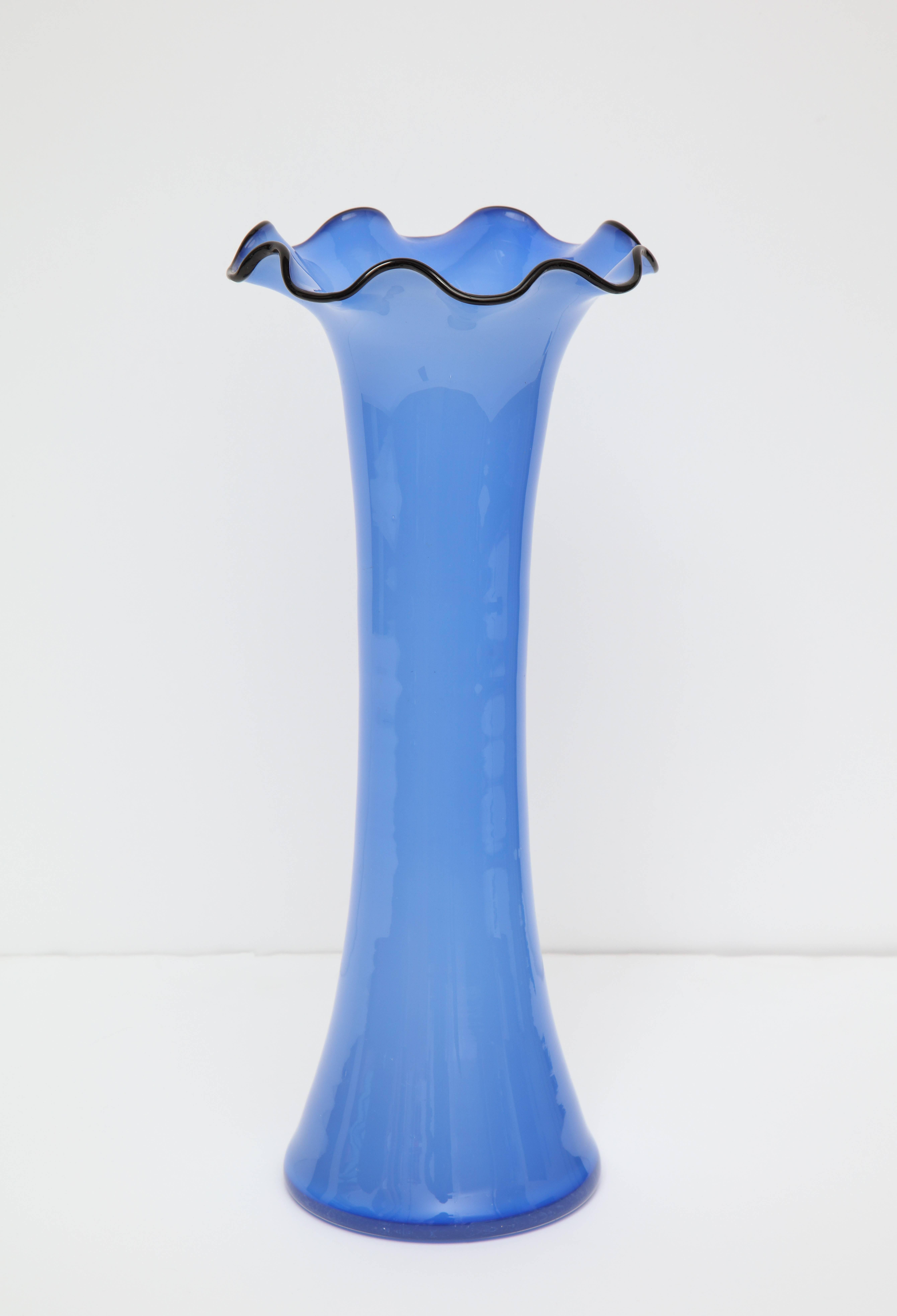Czechoslovakian handblown blue glass vase with a flared flower petal shaped top rimmed in black.
Czechoslovakia, circa 1920
Size: 14