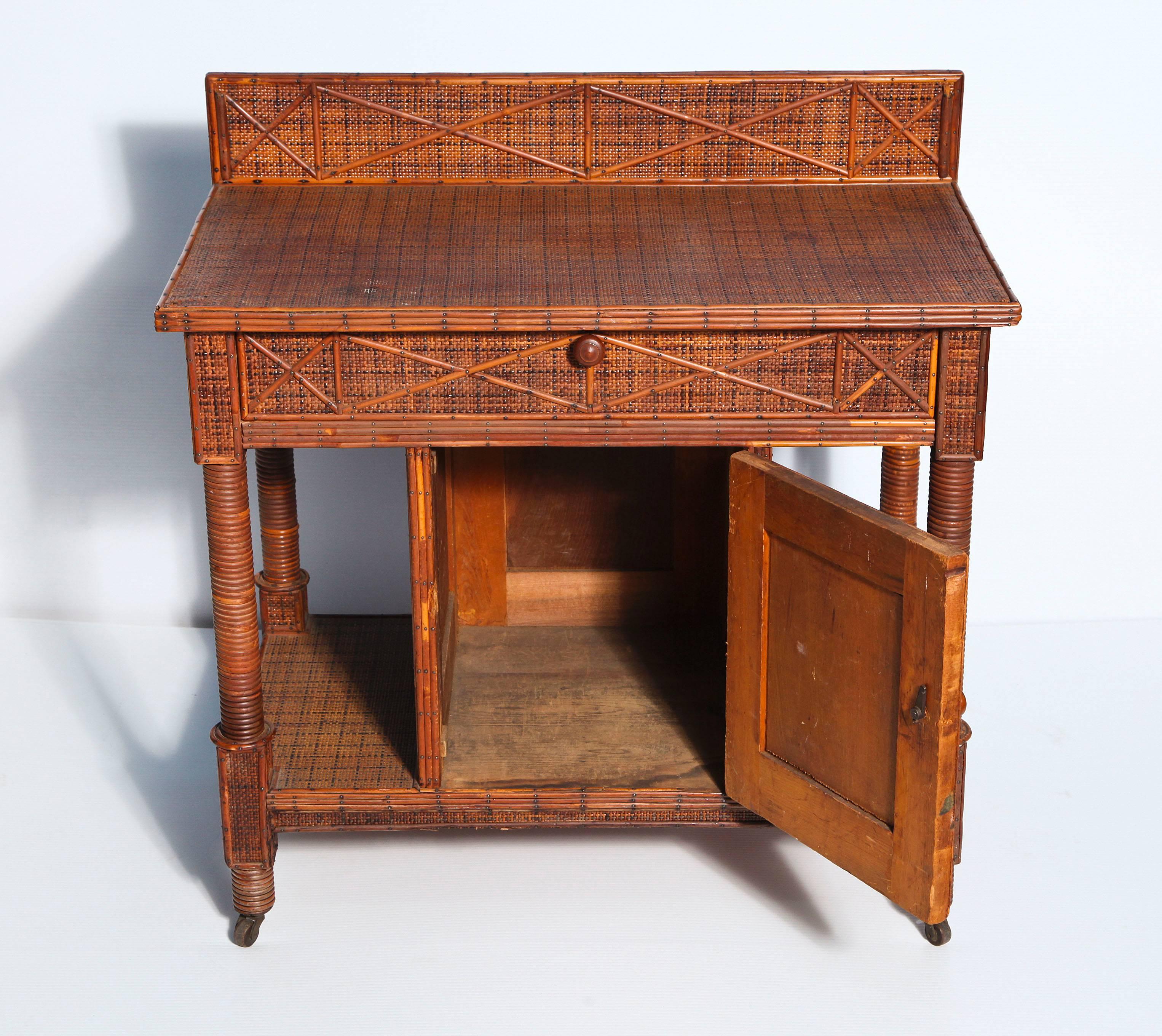 A handsome side cabinet in woven and split rattan, fitted with single drawer
and storage cupboard and raised on casters.
 