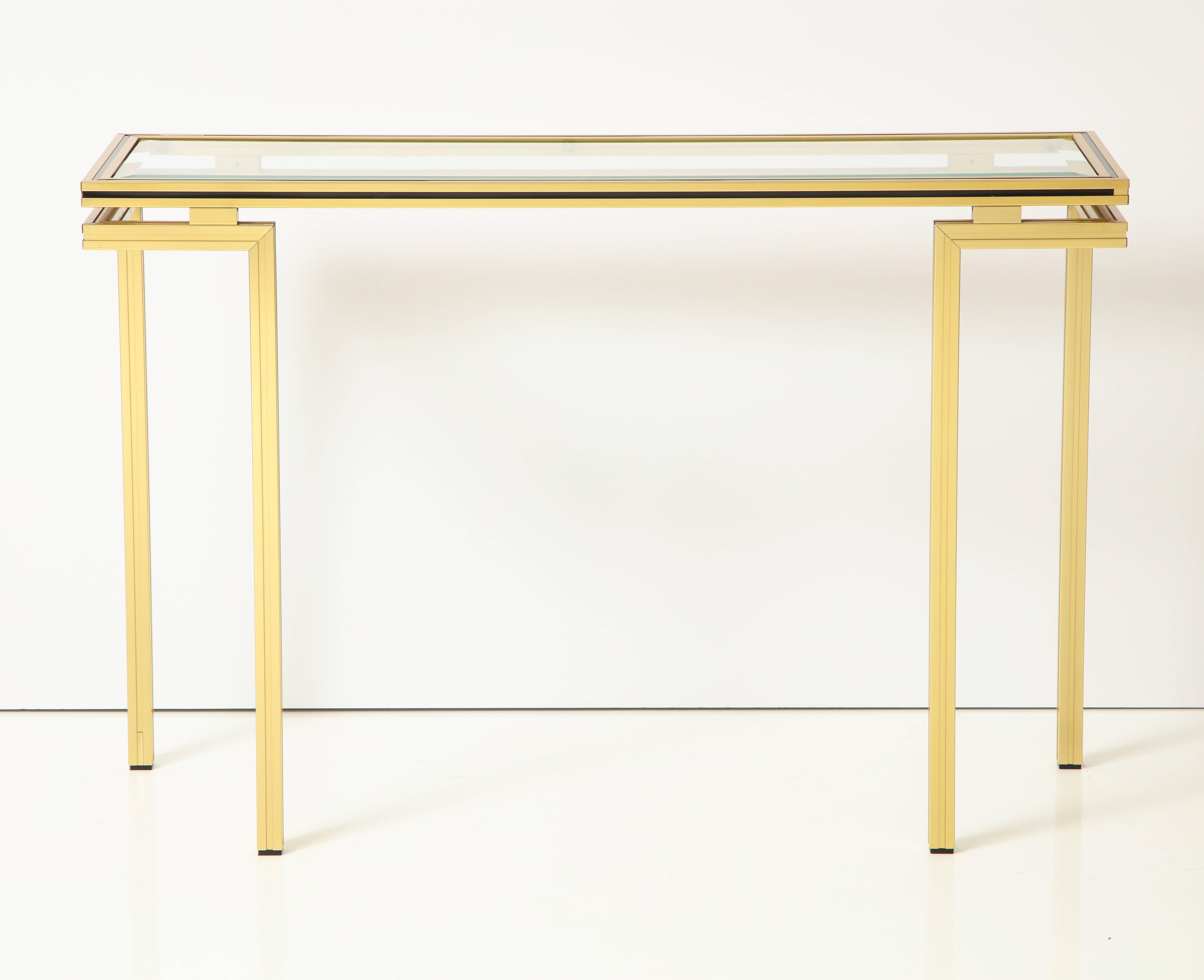 A very elegant and timeless pair of Pierre Vandel brass console tables with inset beveled glass and ebonized trim.
Signed Pierre Vandel on top of both tables. 
Paris, France circa 1970
