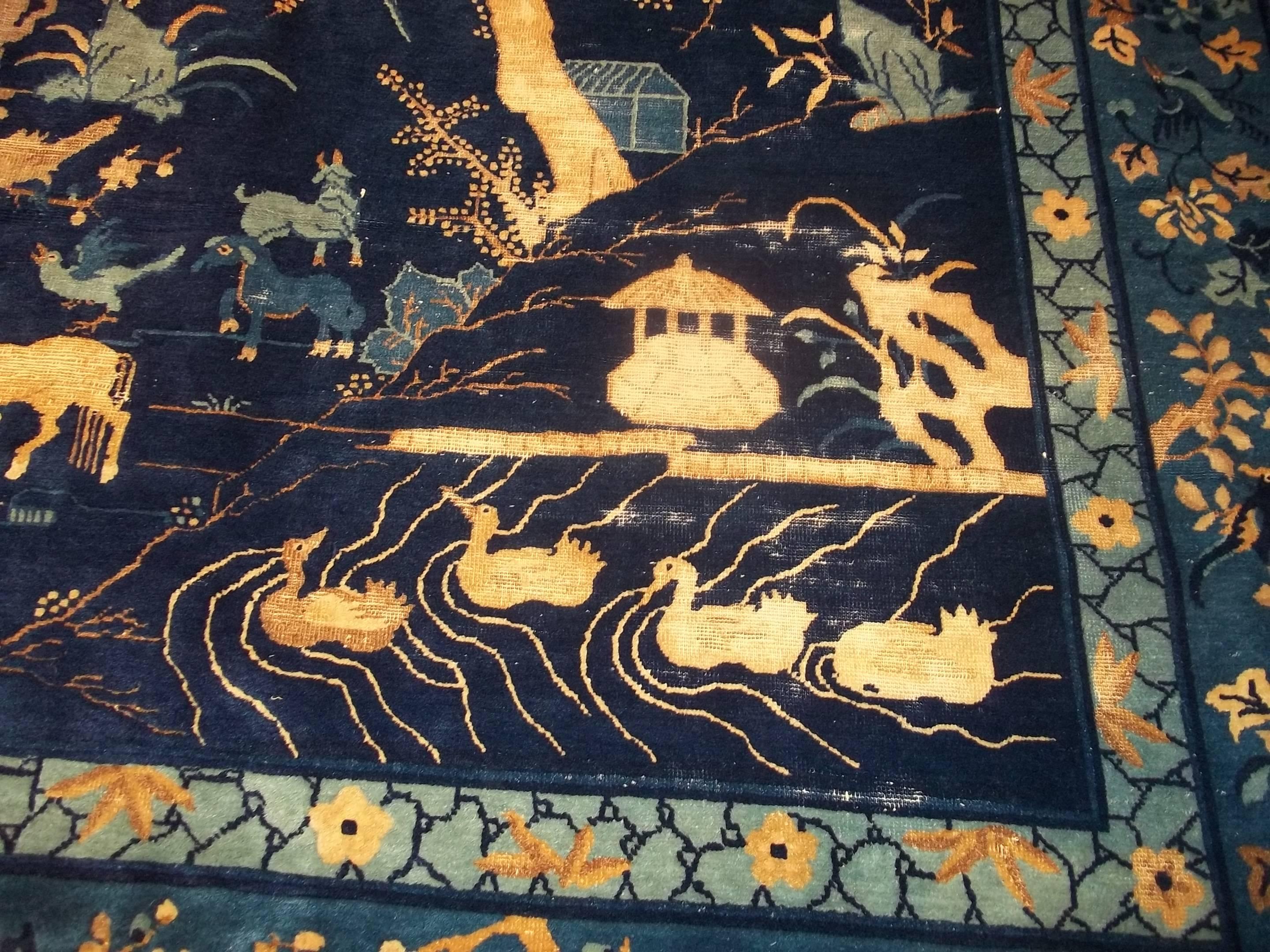 This circa 1880 Peking Chinese rug (INV 6888) measures 12’0” by 14’5” (371 x 441 cm).  It is totally covered in mythological beasts and true animal images.  There are four ducks swimming in a lake.  There is the sacred mountain with a horse grazing