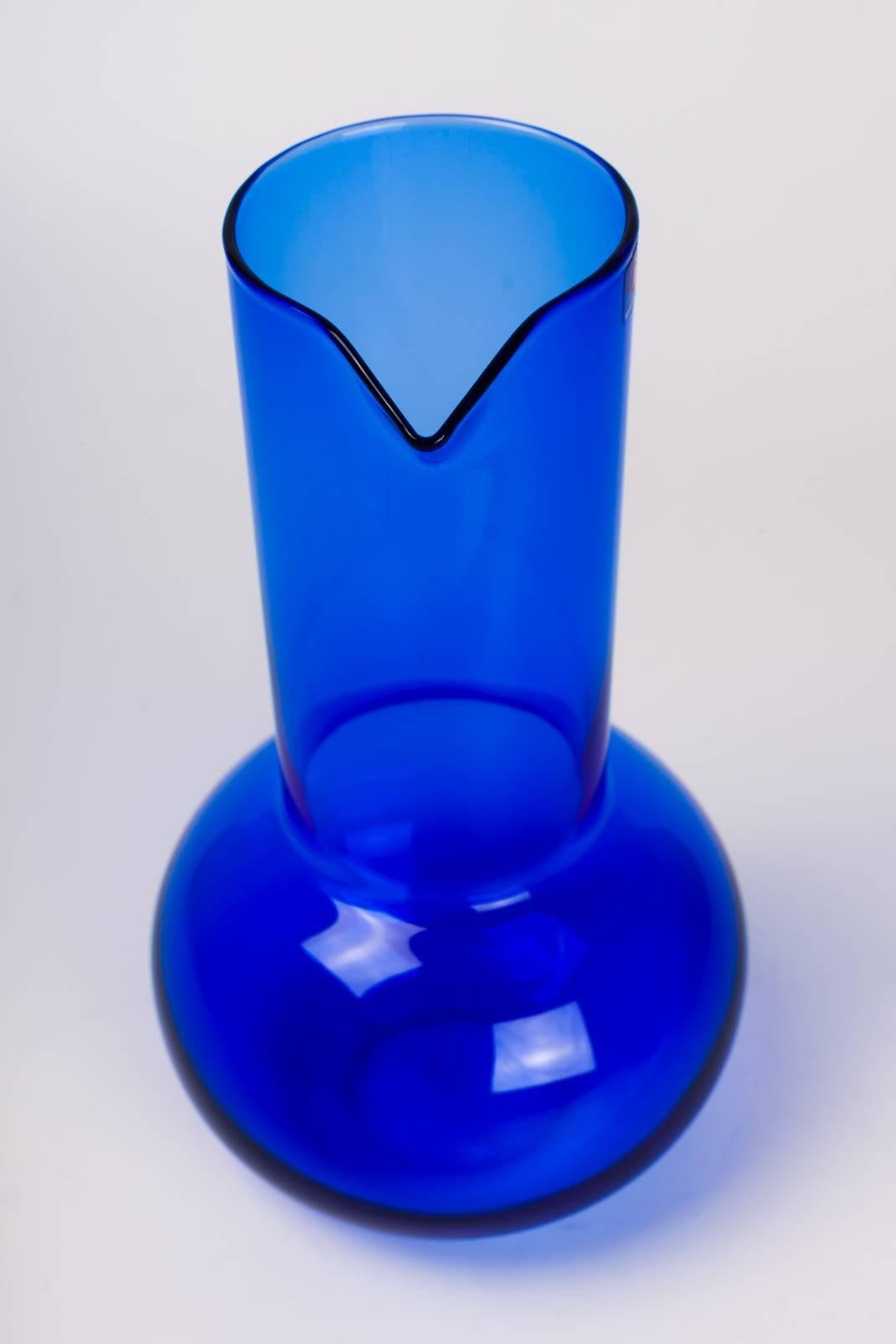 Brilliant blue decanter designed by Kaj Franck in the 1960s. Ergonomic neck and spout with generous, round vessel. It can be used at the table or displayed as a decorative object on a shelf or table. 

Founded in 1881, littala is the most