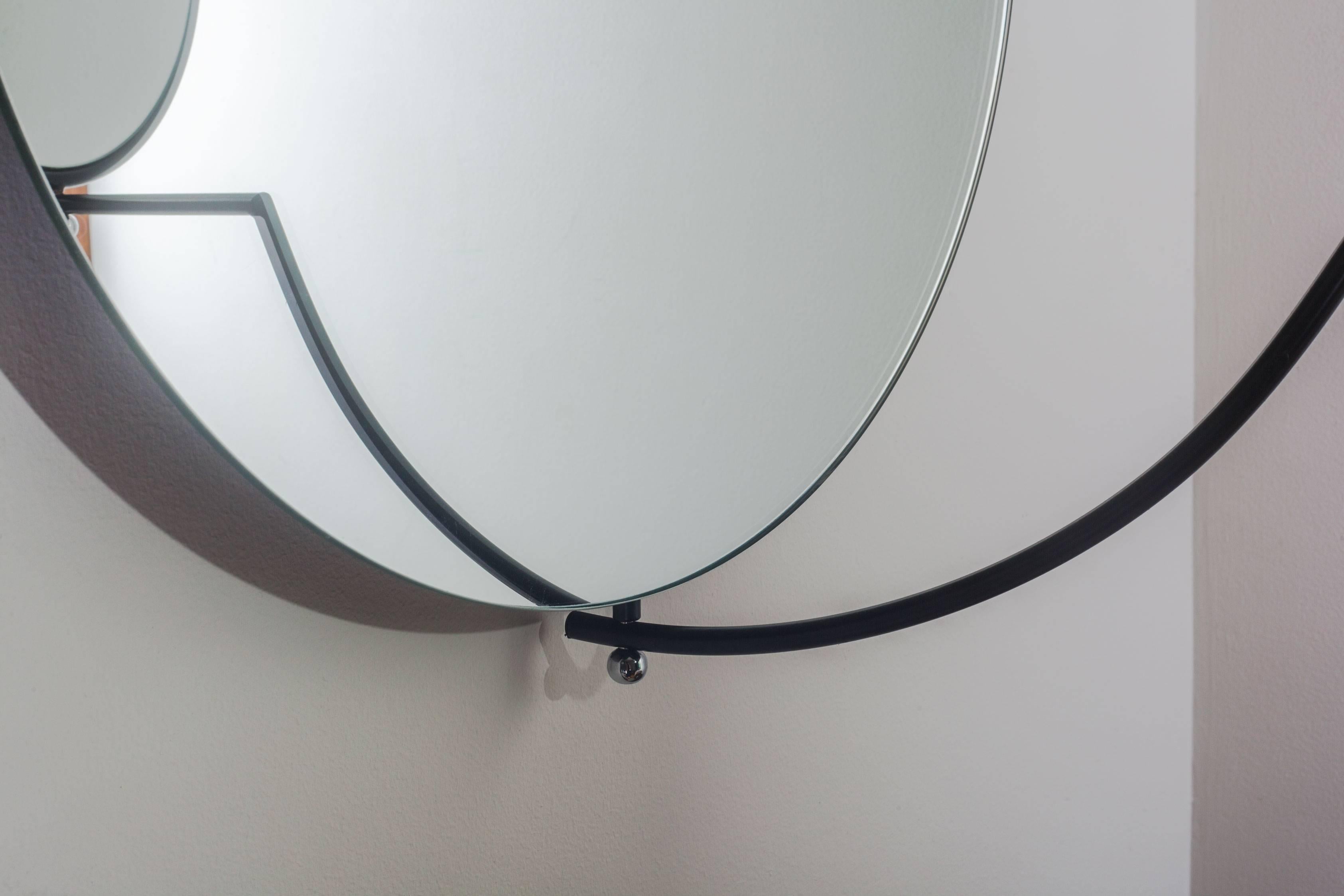 Round double wall mirror by Rodney Kinsman for Bieffeplast, Italy. The large main mirror is fixed to the wall with a built in backplate that allows for horizontal hanging as pictured, or vertical hanging. The mirror's steel frame pivots at 180