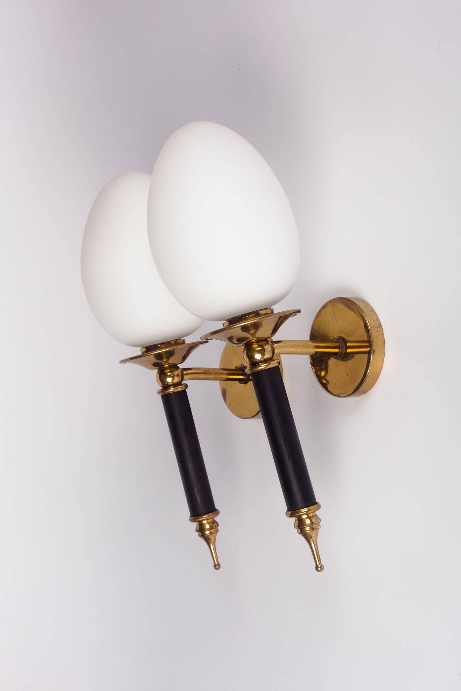 Pair of French sconces in glass, brass and painted metal. Egg-shaped milk glass diffusers give a soft textured look. Painted black metal stems with brass details. Made by Arlus in France, 1950s.