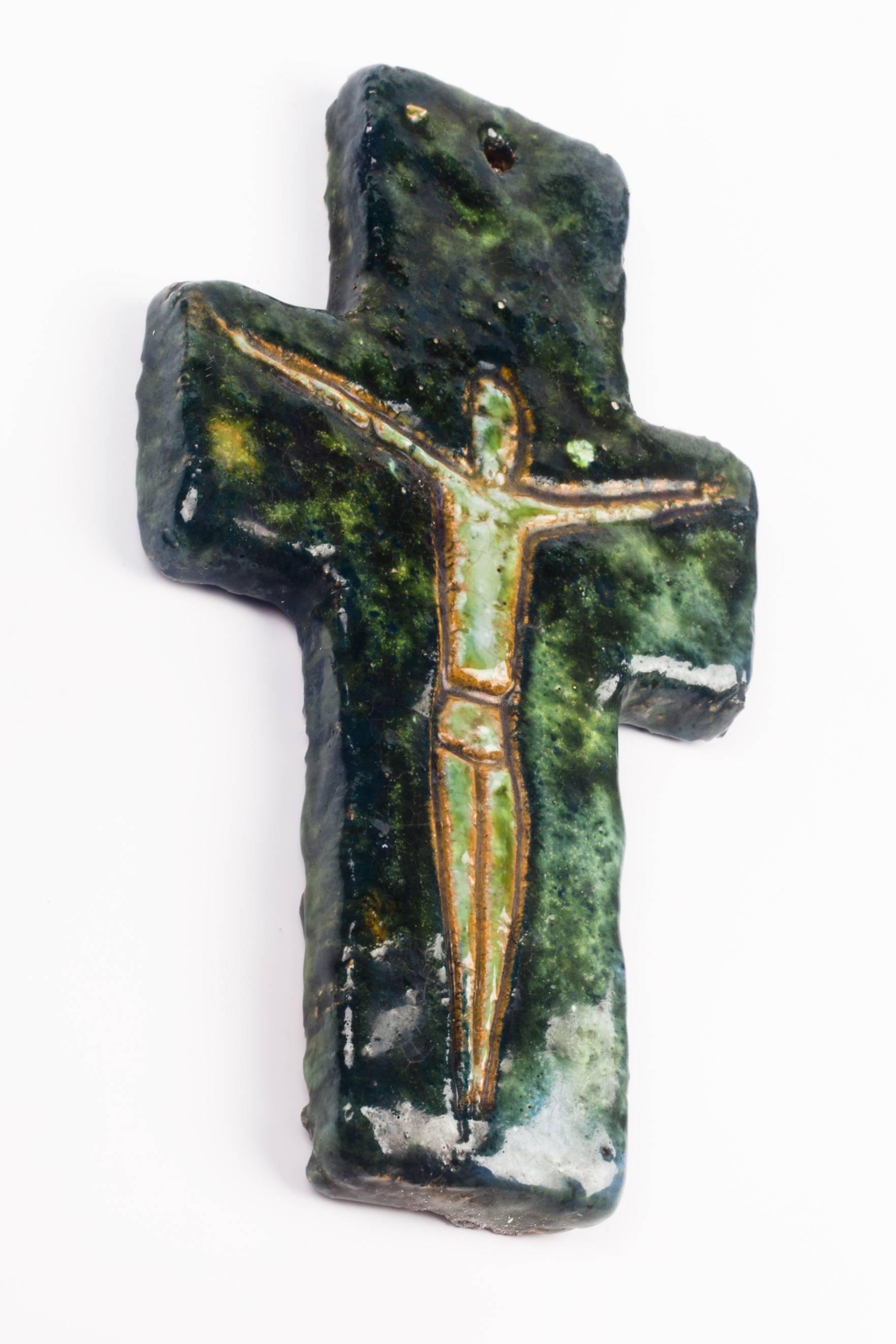 Seven inch tall wall crucifix in ceramic, made in Belgium in the 1970s.
Hand-painted, embossed, glossy yellow and green figure on a cross in glazed dark and light greens.

This piece is part of a 69 piece ceramic crucifix collection, all made in