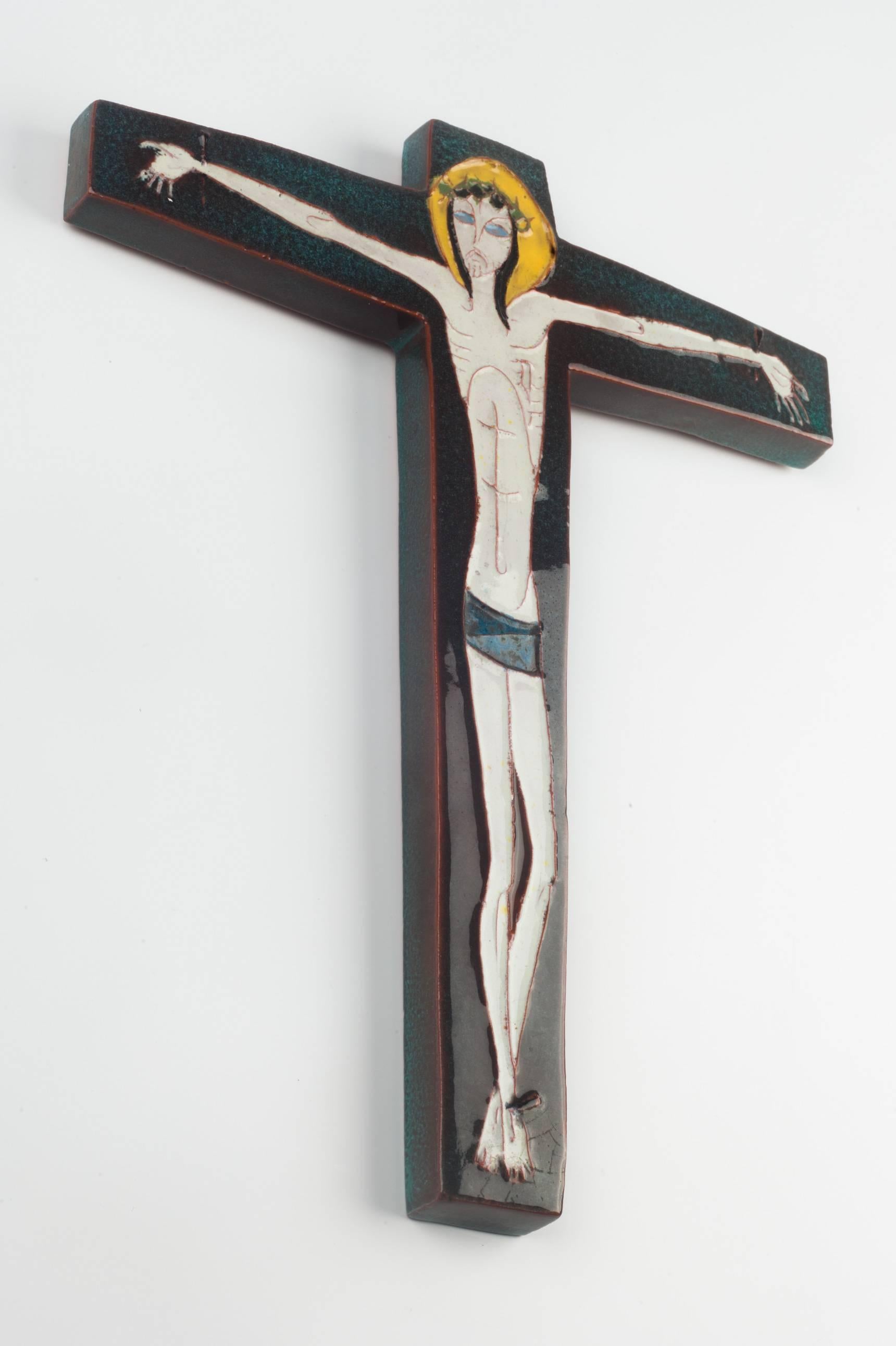 Eleven inch tall wall crucifix in ceramic, made in Belgium in the 1950s.
Deep blue green, light beige and yellow. Christ figure drawn in very delicate lines.

This piece is part of a 69 piece ceramic crucifix collection, all made in Belgium between