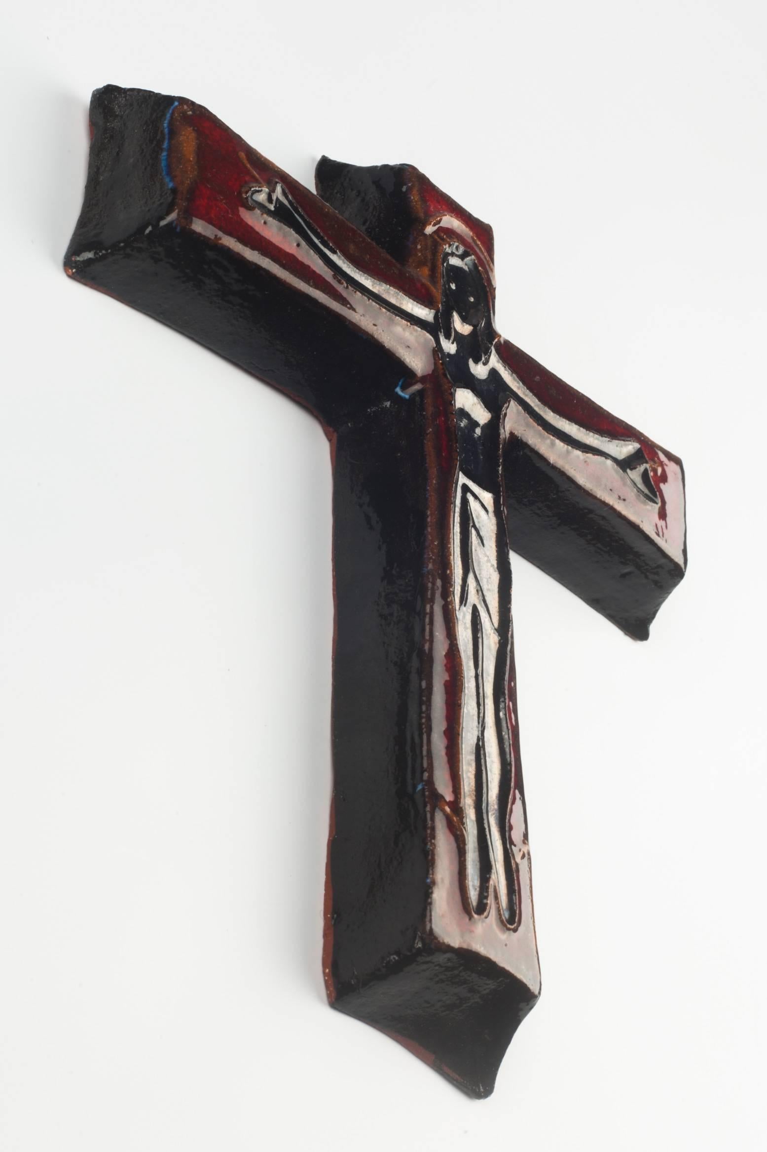 Six inch tall wall crucifix in ceramic, made in Belgium in the 1970s.
Glossy black Christ over dark red cross. Christ figure embossed in soft lines.

This piece is part of ceramic crucifix collection, all made in Belgium between the 1950s and late