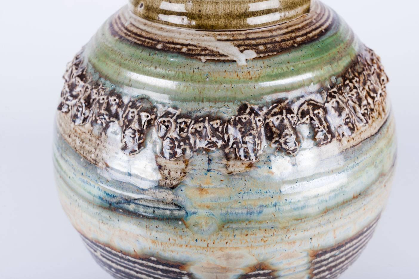 Raku Vessel by Phil Mundt, Hearth Tones and Green Blue, Faces Crown Detail, 1970 In Excellent Condition In Chicago, IL