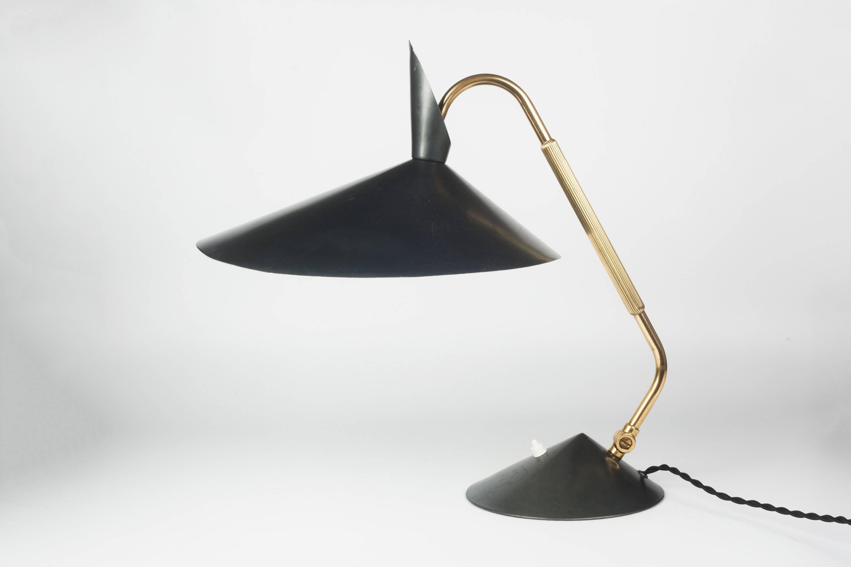 Large desk lamp in elephant grey and brass by Kaiser Leuchten. Made in Germany, 1960s. Large, organic shaped saucer shade and weighted pyramid base. At once classic and otherworldly, this lamp commands a strong presence in a room. Bakelite switch.