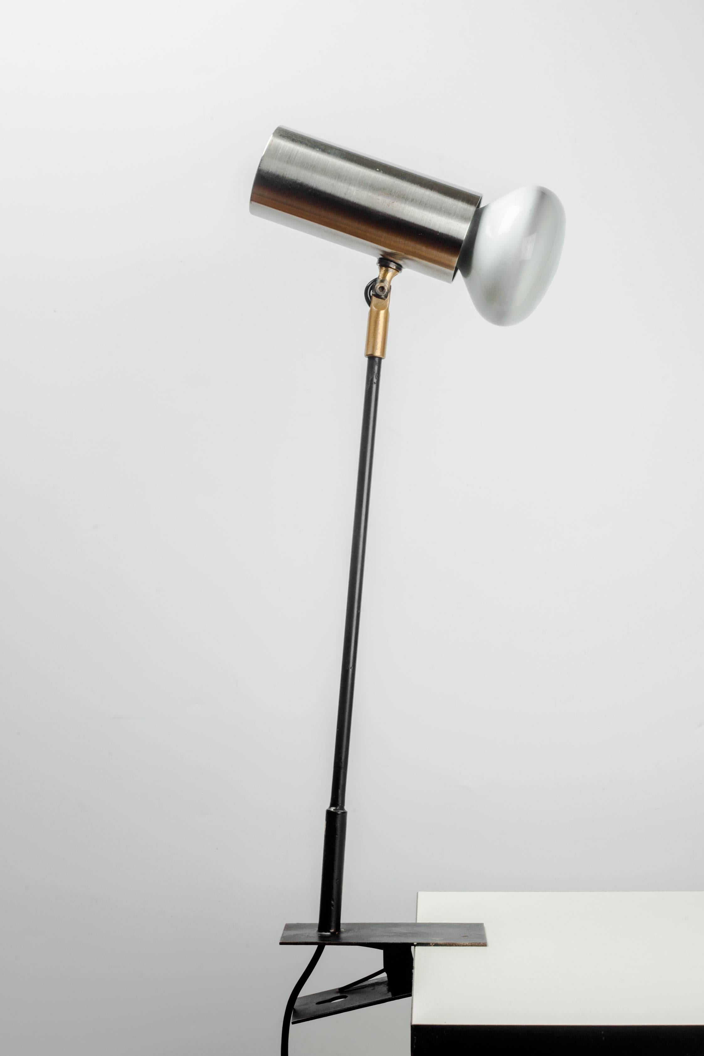 Elegant, vintage 1950s French desk lamp with shade made of brushed aluminum. At the end of the black metal neck is a clamp for attachment to a desk, table or shelf. Recalls designs by Jacques Biny, Jean-Boris Lacroix and Alain Richard, it's a