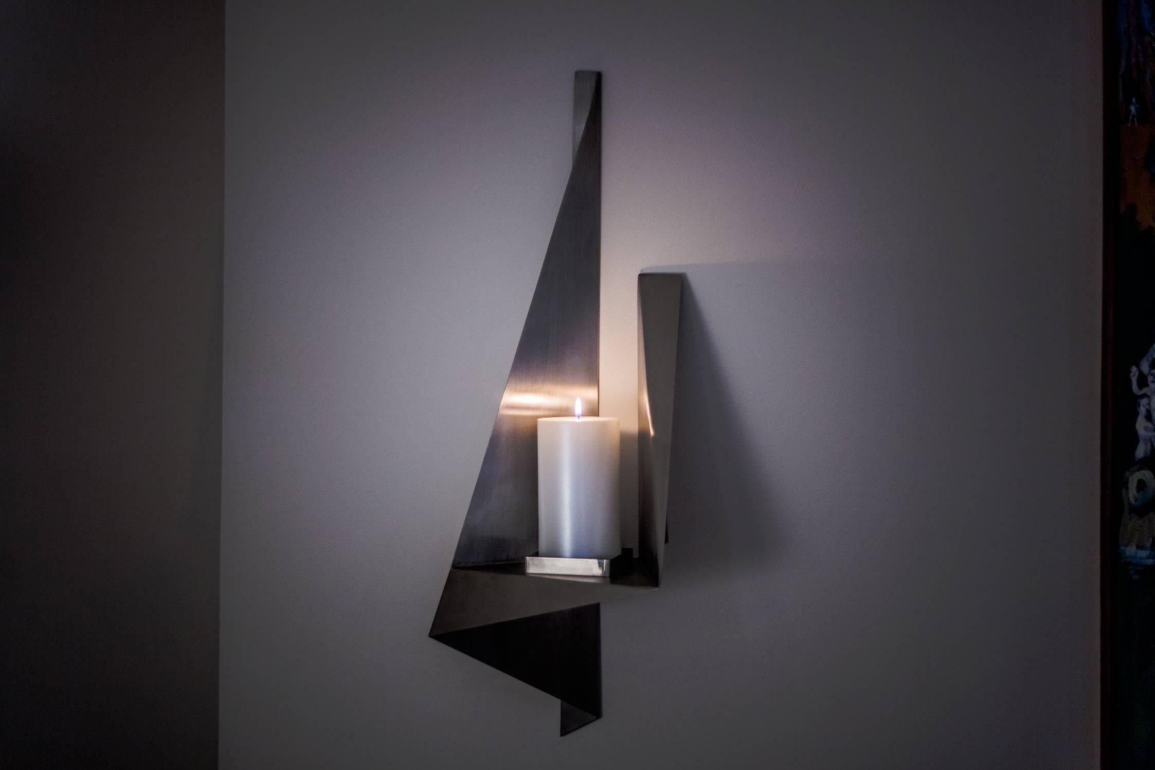 Large, asymmetrical metal wall sconce for pillar candle. This unique, sculptural, vintage wall art is made of stainless steel and reflects light beautifully. A bold and abstract accent piece that draws attention. 