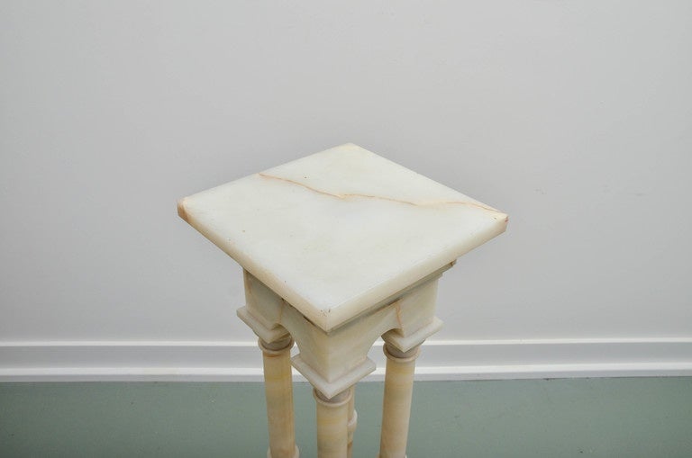 Comprising four columns banded in the center on tiered square base. Topped with arched cornice with swivel top.
