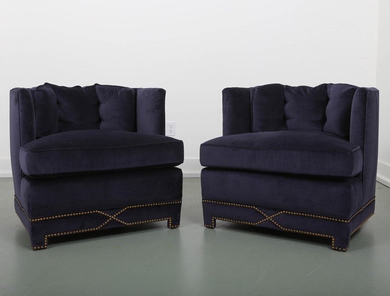 A unique pair of club chairs with five-sided backs. They have been reupholstered sleek blue velvet with nailhead details. 50/50 down/foam seat cushions and 100% down back cushion.