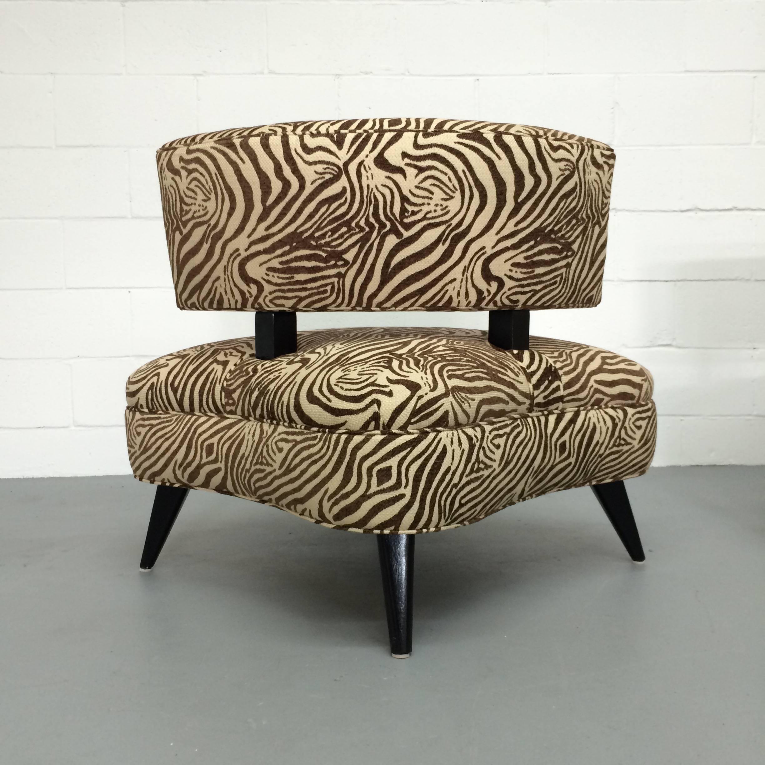 These fun funky 1950s vintage chairs have been reupholstered in a soft, durable zebra print in browns and creams. The print on each chair matches the other chair on the seat and on the back. The legs, which jut out at an angle, are black with a semi