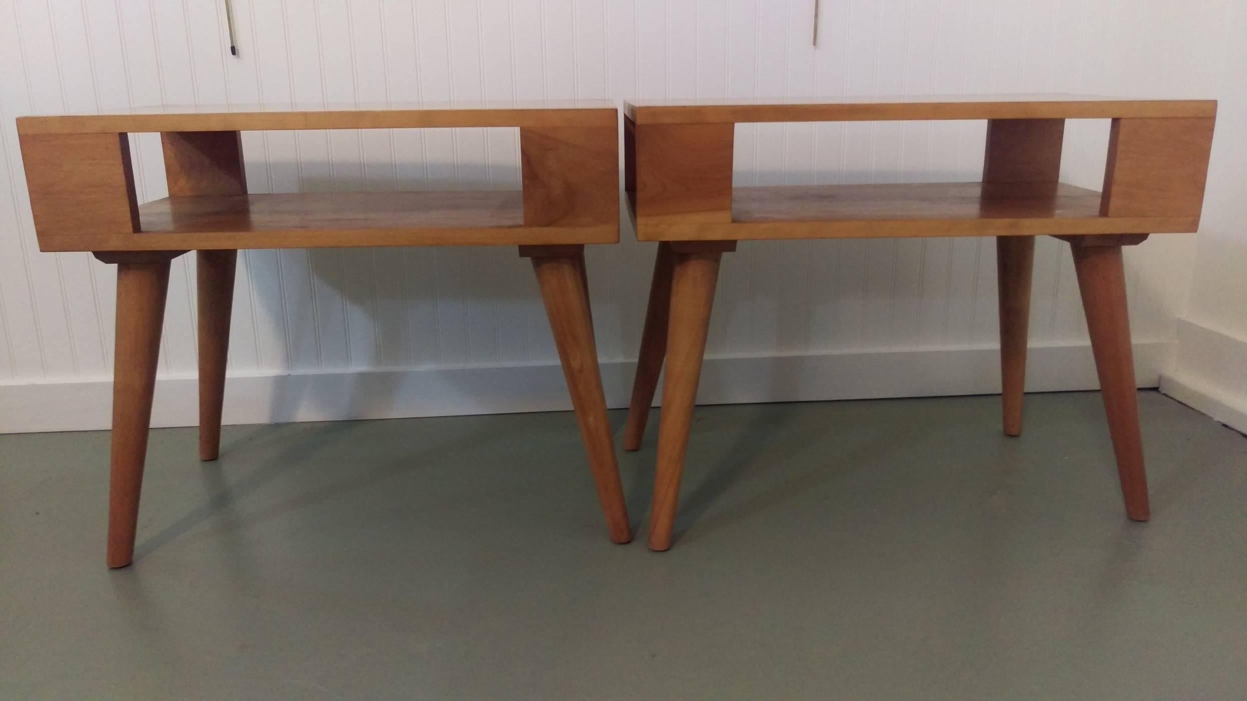 Versatile pair of modernist and architectural form end tables or nightstands. Designed by Russel Wright for Conant Ball International. Constructed in solid maple, in its original condition shows minor wear consistent with age and use.